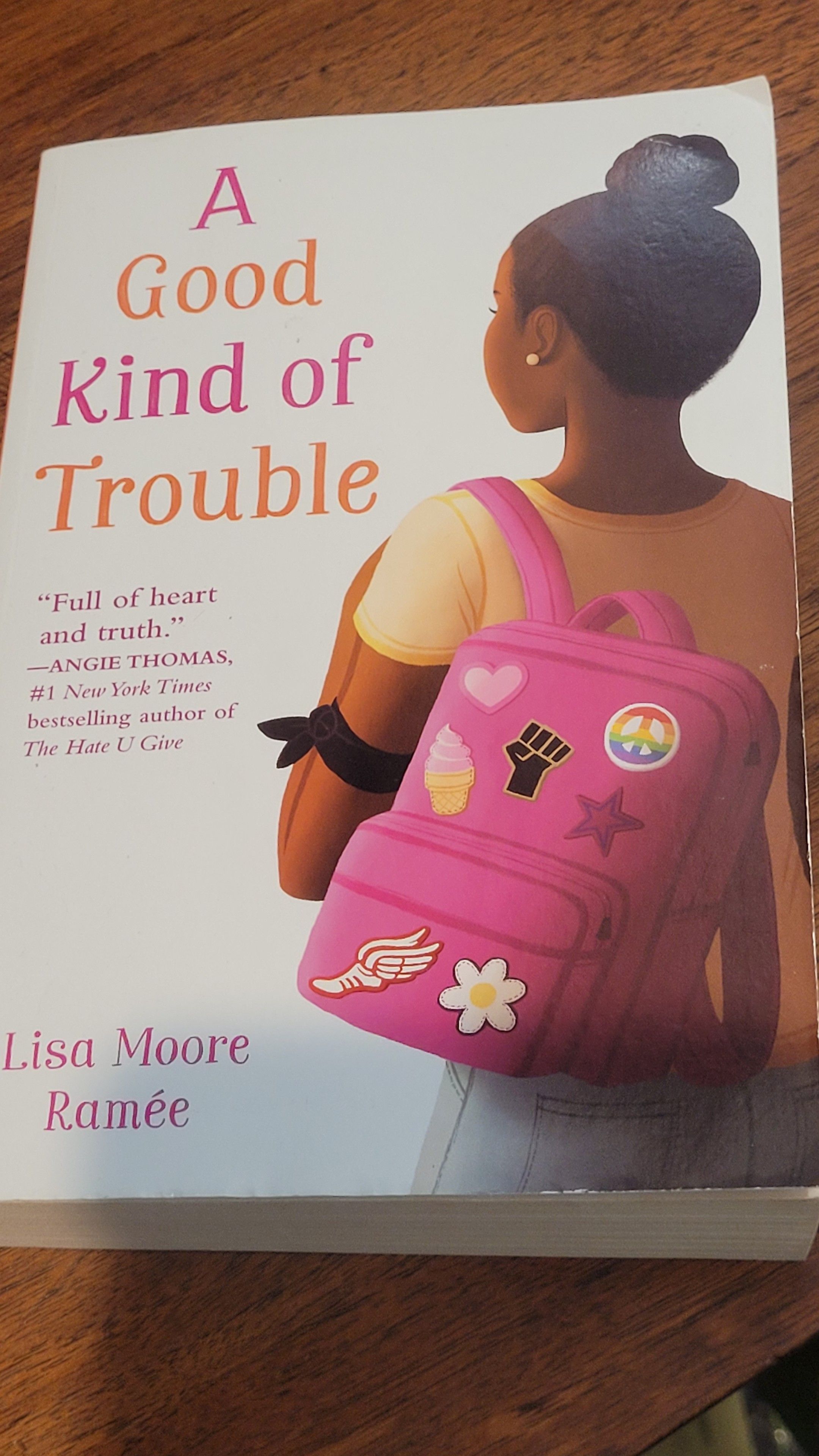 BOOK A good kind of trouble showing a Black girl with a backpack with Black Lives Matter and rainbow peace sign
