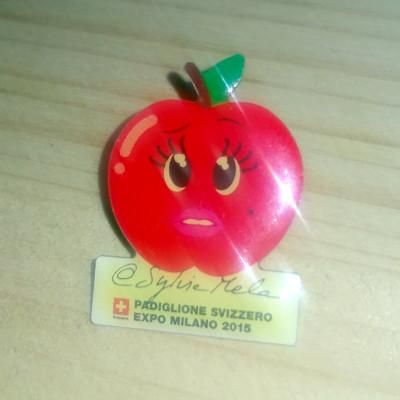 The metallic pin of Sylvie Mela, the mascotte of the Swiss pavilion at Exposition Internationale held in Milan in 2015. The mascotte is an antropomorphic apple.