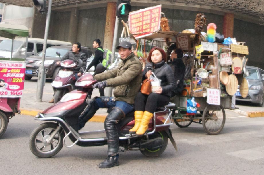 a couple sits on what looks like a stretch scooter