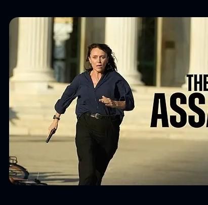 Zoom in on film to the right of a scroll selection. An intense looking woman with a gun is doing some running or something and the name of the film?.....

THE ASS

(I assume it's Assassin, but it's been cut off) 