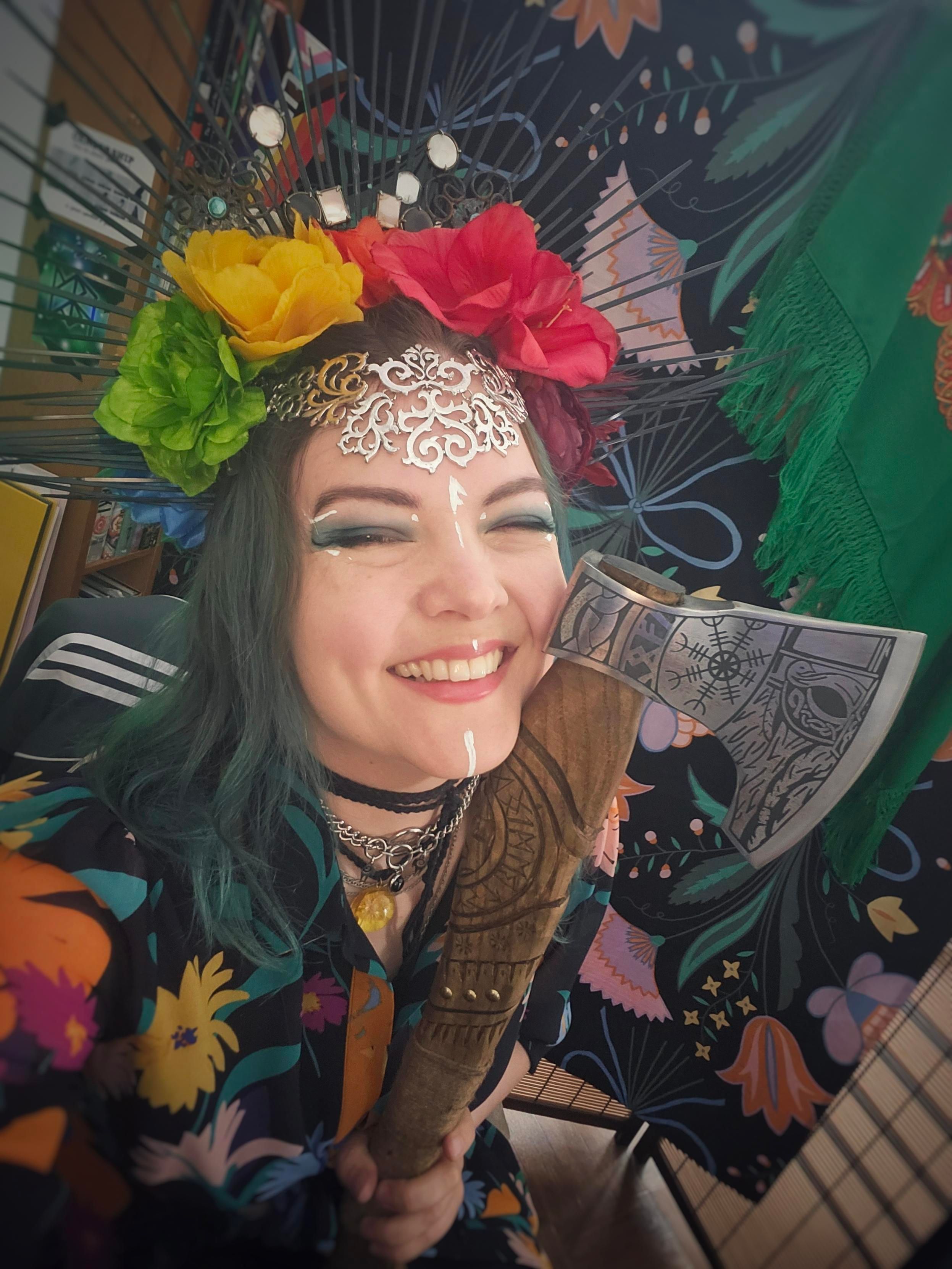 Dressed up flowery Jen taking a selfie with her wedding anniversary axe.