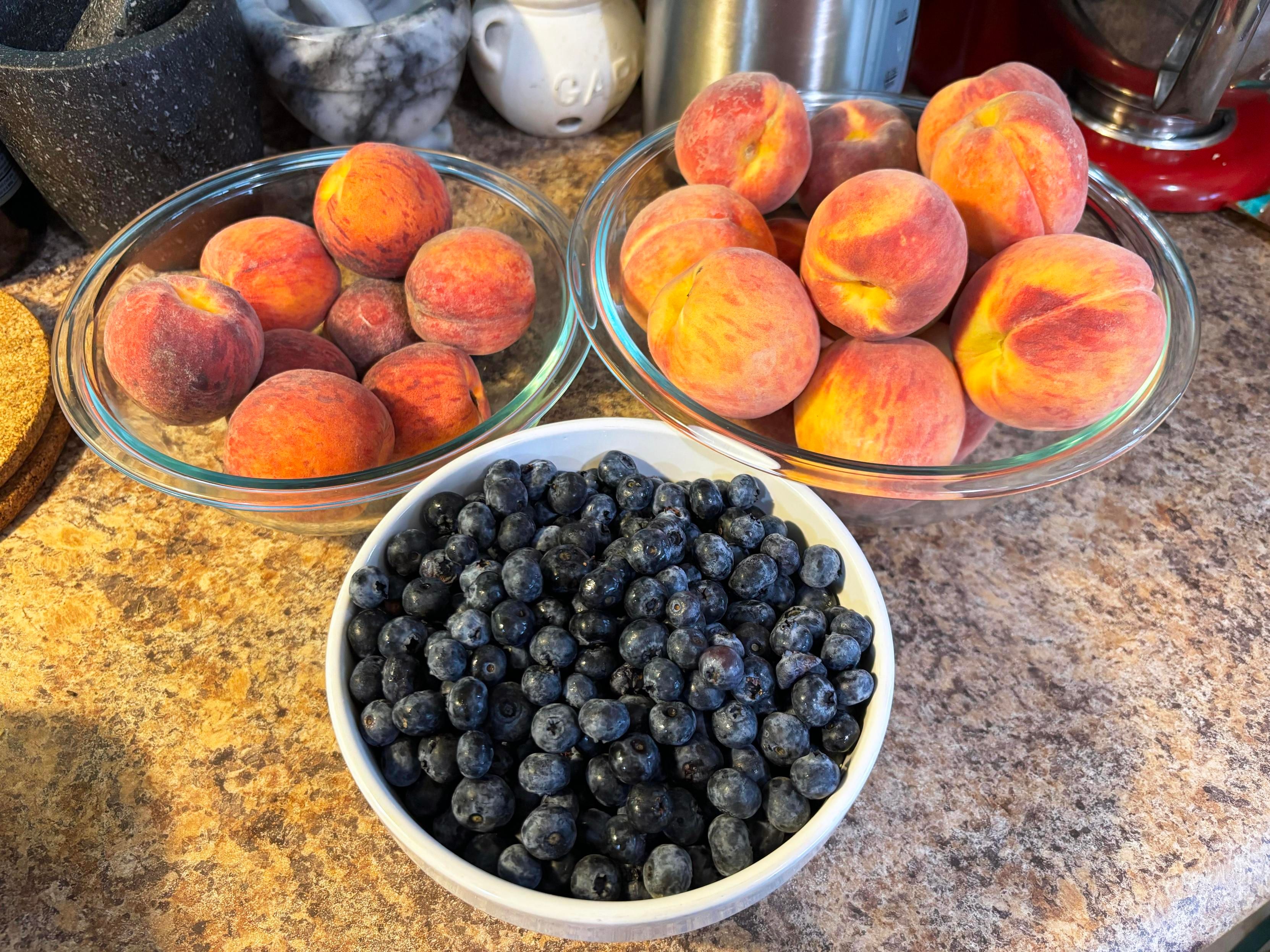 Bowls of Ontario Peaches and blueberries on my overcrowded counter.