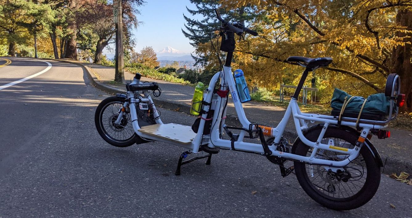 picture of electric cargo bike parked next to Terwilliger parkway with Mt Hood in the background