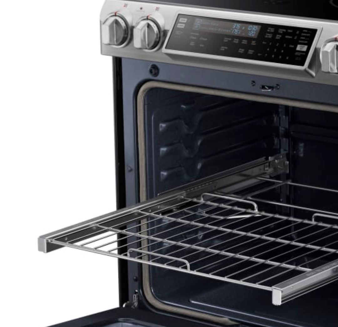 A promo photo shows an oven with an open door, and a protruding sliding shelf, which has a raised lip or handle on the front edge. It really gets in the way.