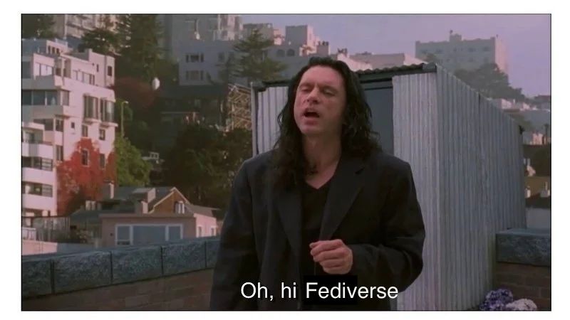 Tommy Wiseau in The Room playing Tommy, exiting the fake little rooftop structure, eyes closed, saying awkwardly "Oh hi Mark" but in the subtitle I replaced the line with "Oh hi Fediverse"