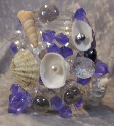 Glass jar covered in shells, purple acrylic gems, lavender glass stones and faux pearls. All my aquarium ornaments use only fish safe 100% Silicone glue.
