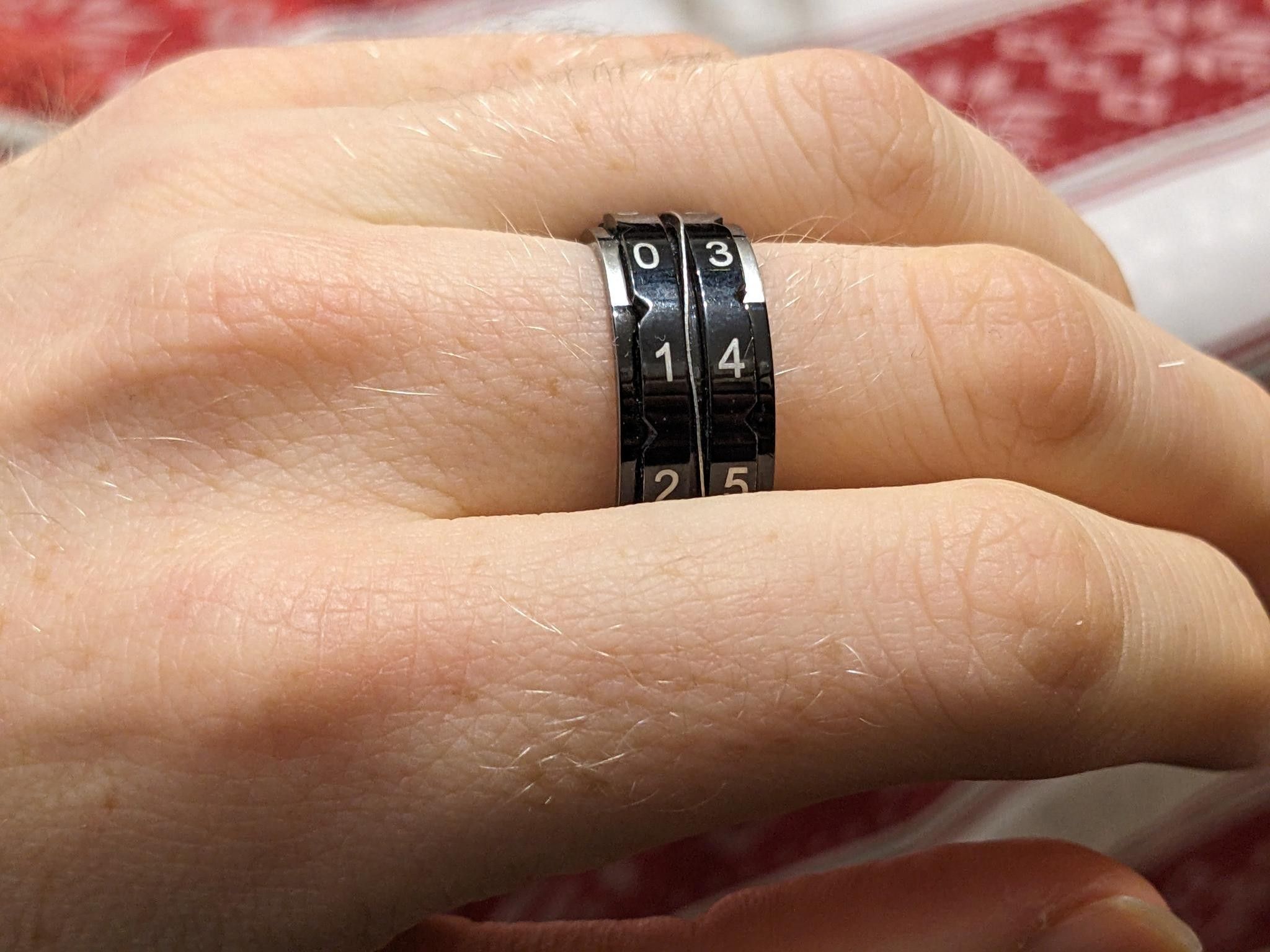I'm wearing a black ring with silver numbers – you can rotate pieces of it to make the numbers 00 to 99.