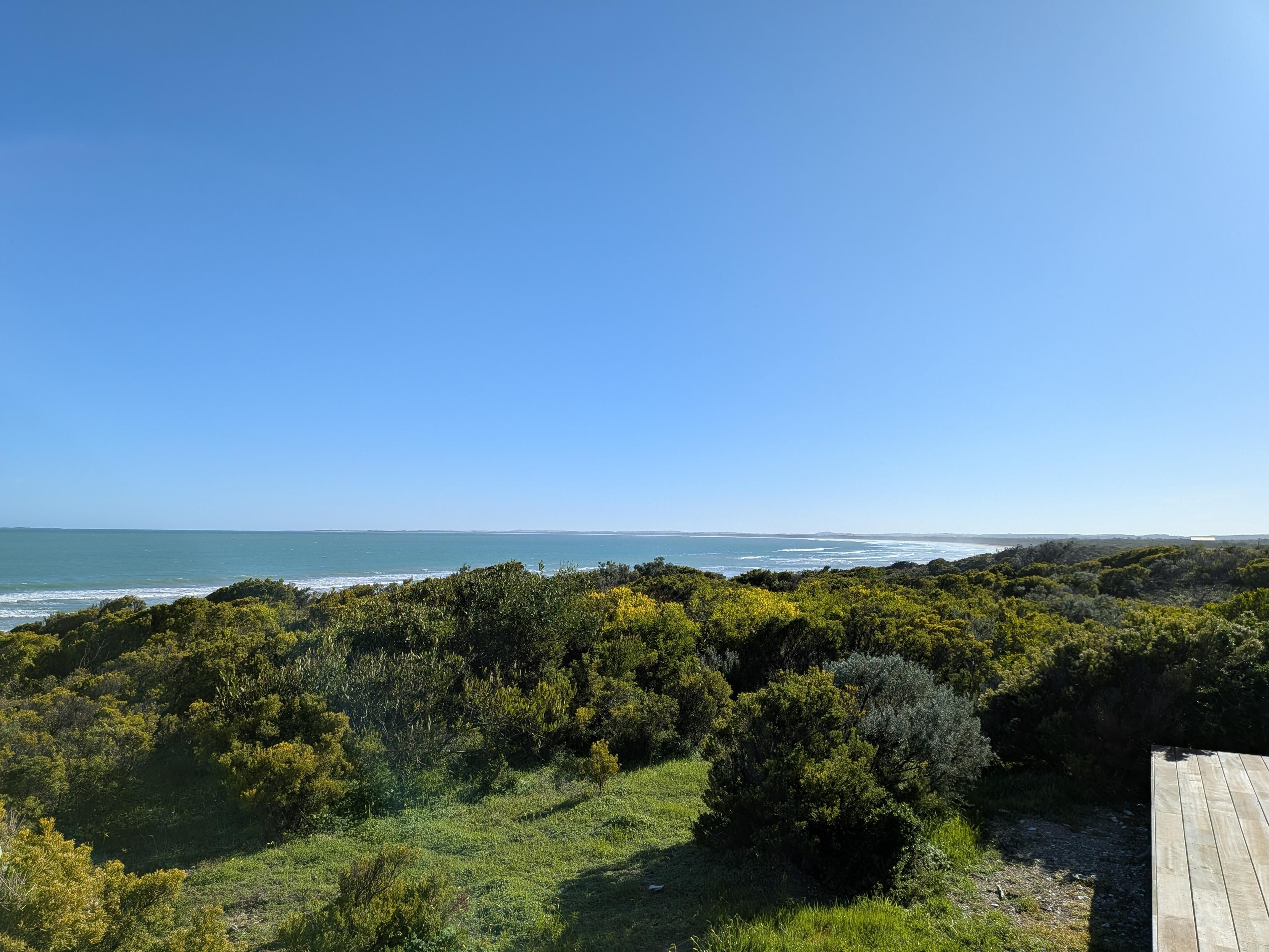 View of the ocean and beach on a clear day. 