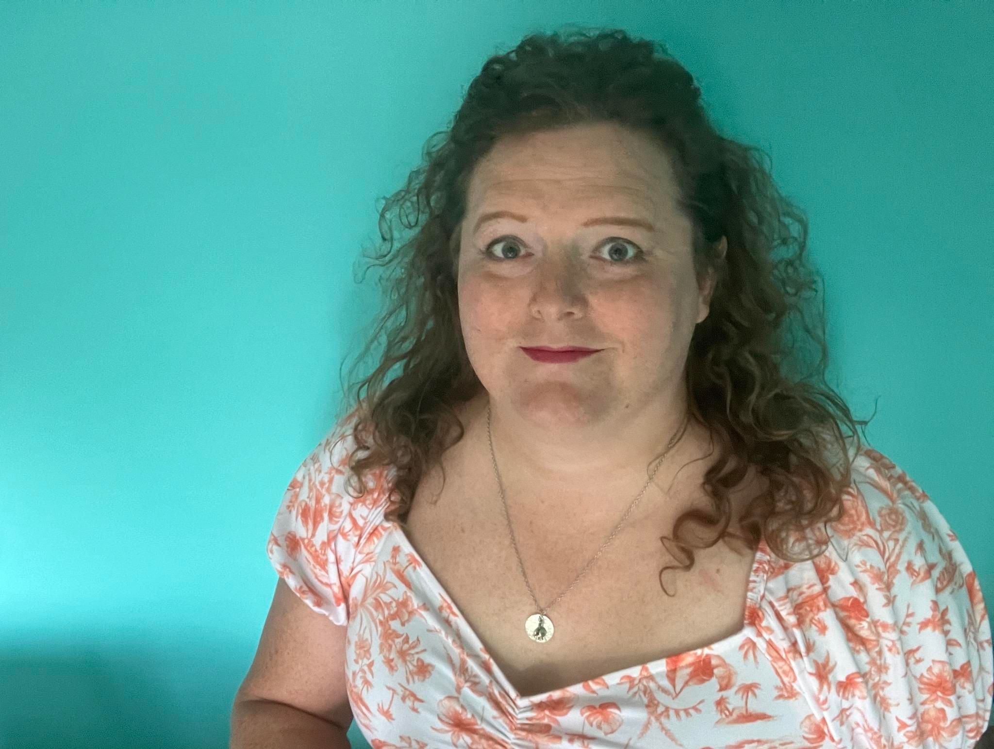 miriam, a white trans woman early in hormonal transition, looking vaguely hopeful