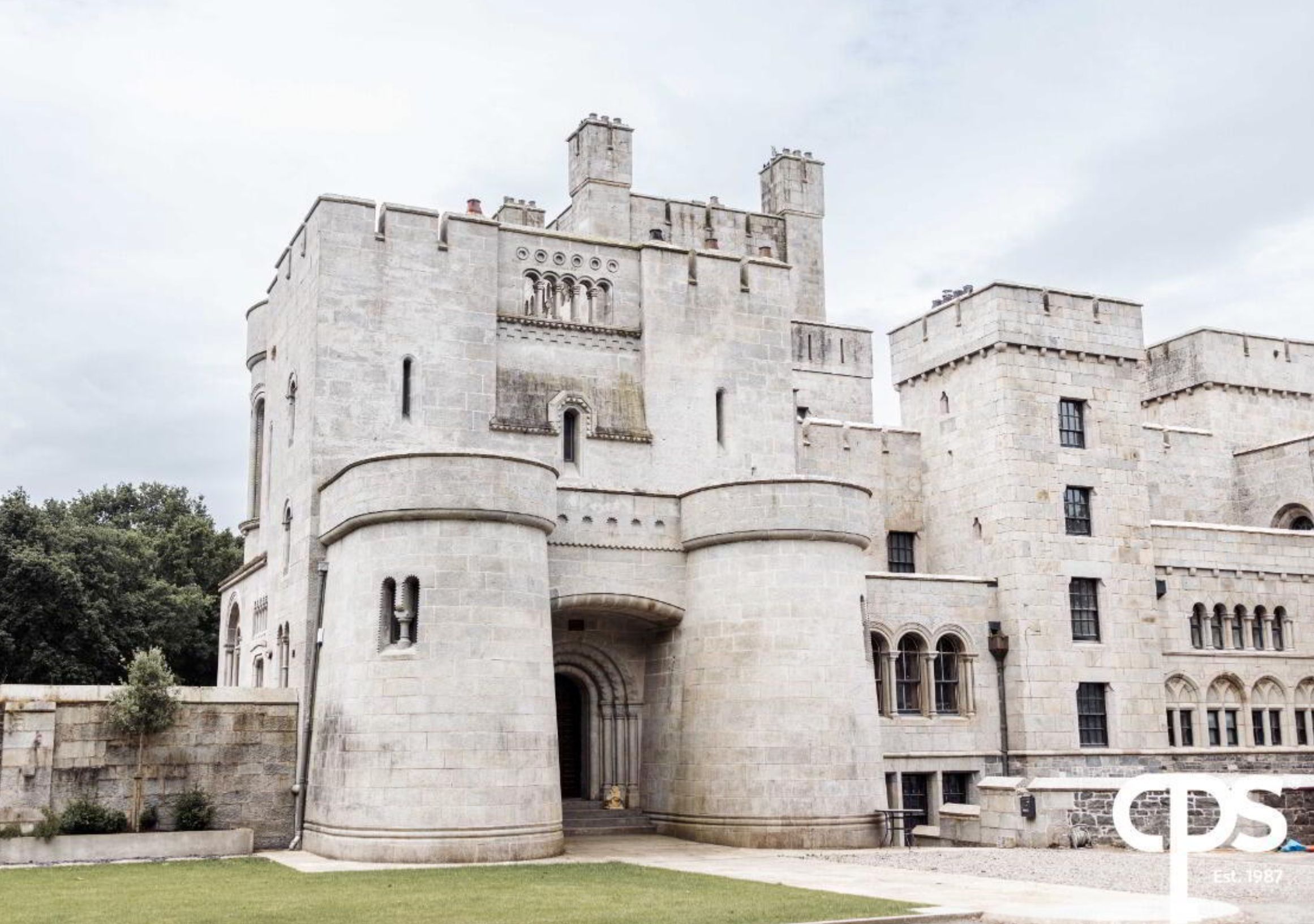A several story huge grey faux castle that was built in the 1800s but made to look medieval. It does not look like the average 3 bedroom semi-detached house. 