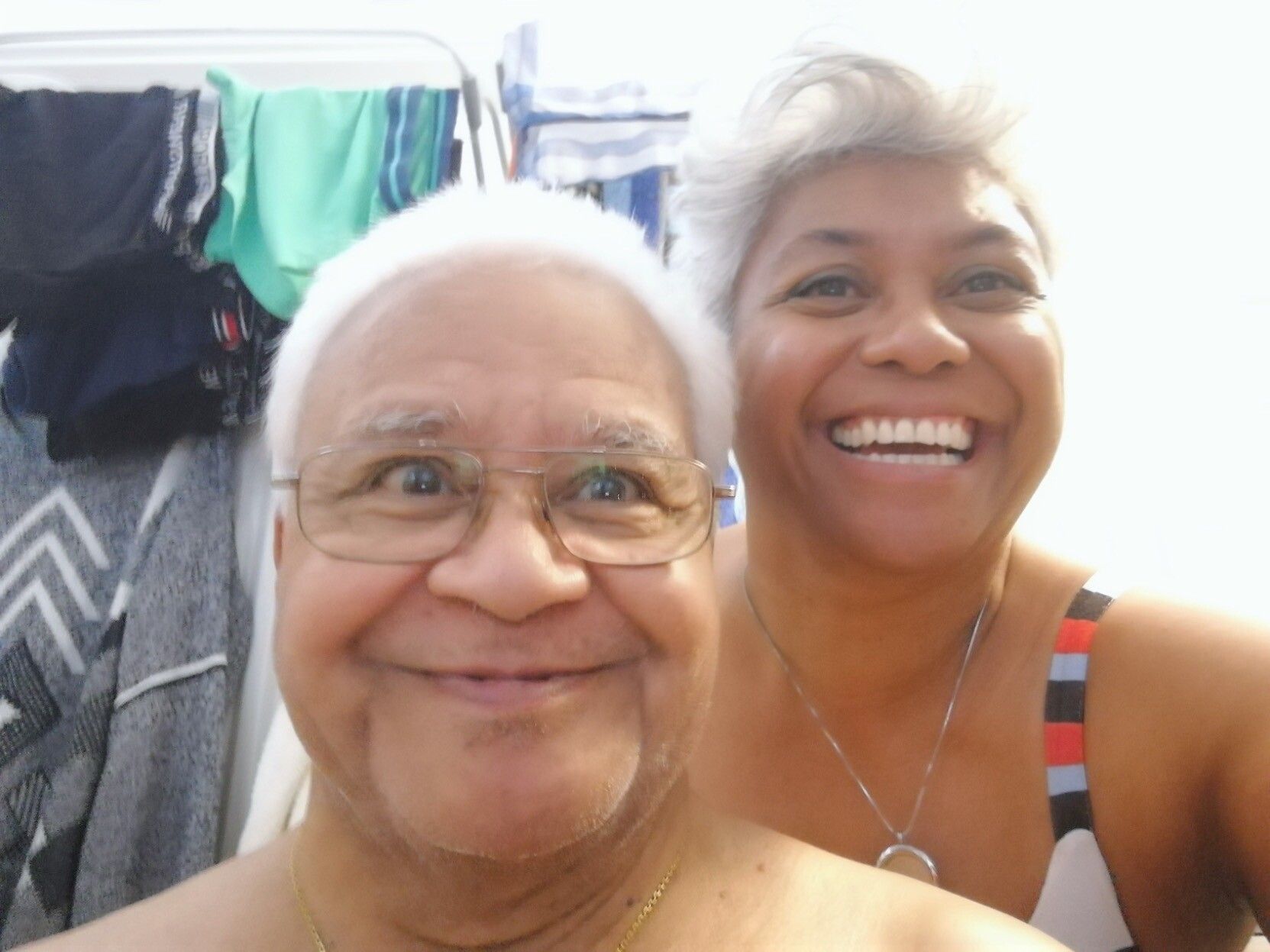 Black man, white hair, having fun with his equally white haired daughter

About to have his hair cut in the bathroom