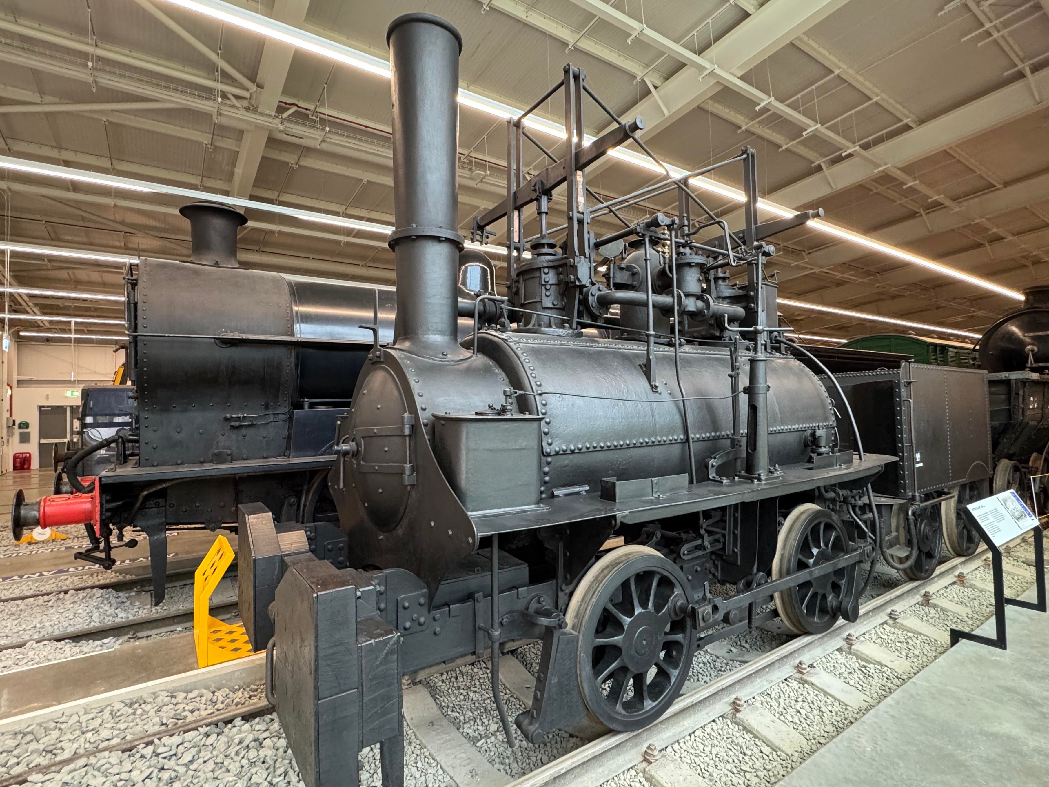 Lyon, an early black steam locomotive with a lot of machinery placed atop the boiler