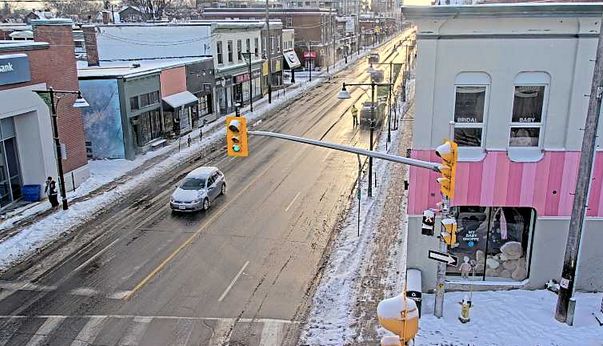 Bank street in the Glebe, with a lone car in the foreground and gleaming wet streets looking south. 