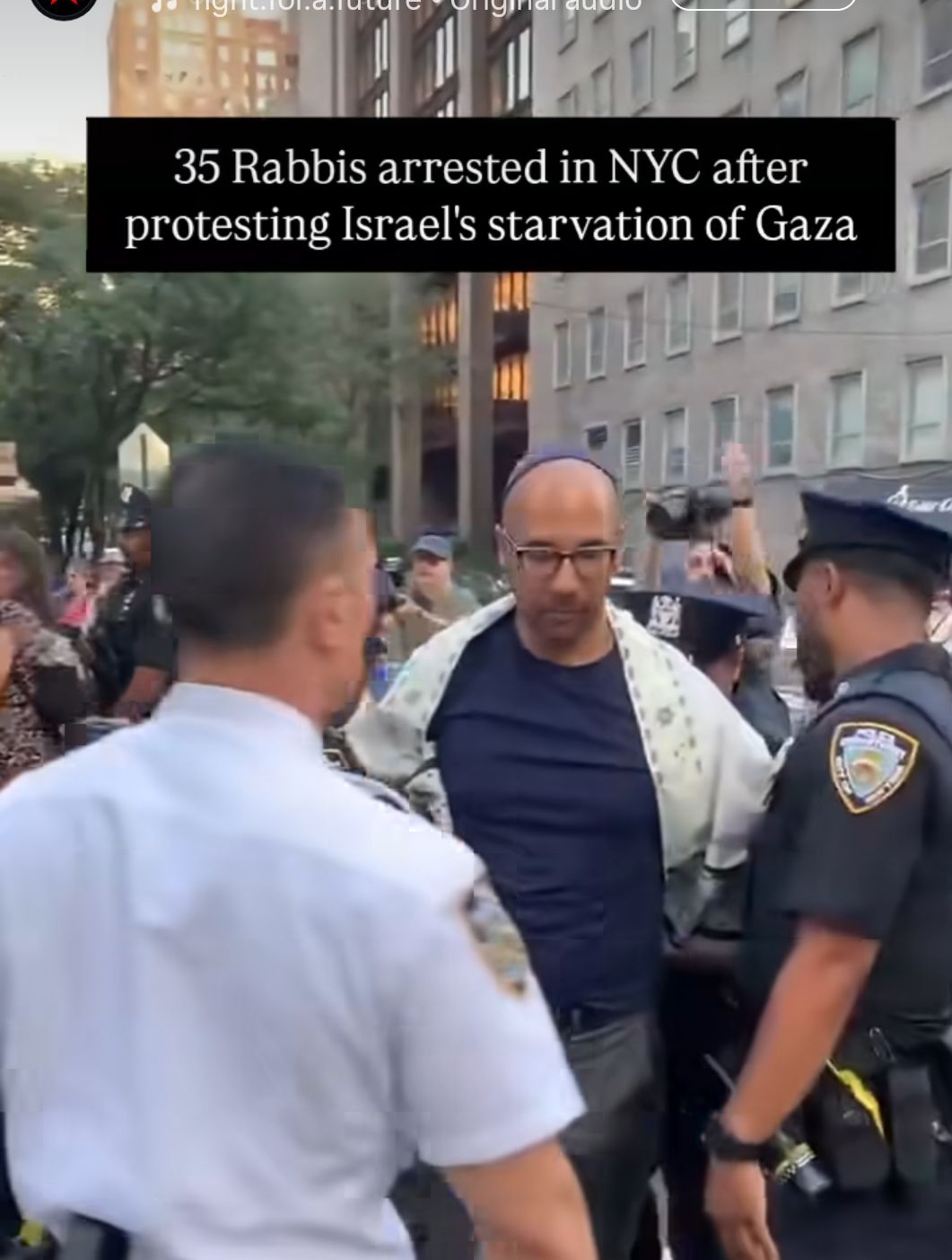 A young Rabbi is arrested by members of the NYPD. He is wearing a Kippah, and his arms are padlocked behind his back 

He looks well hot 😍 