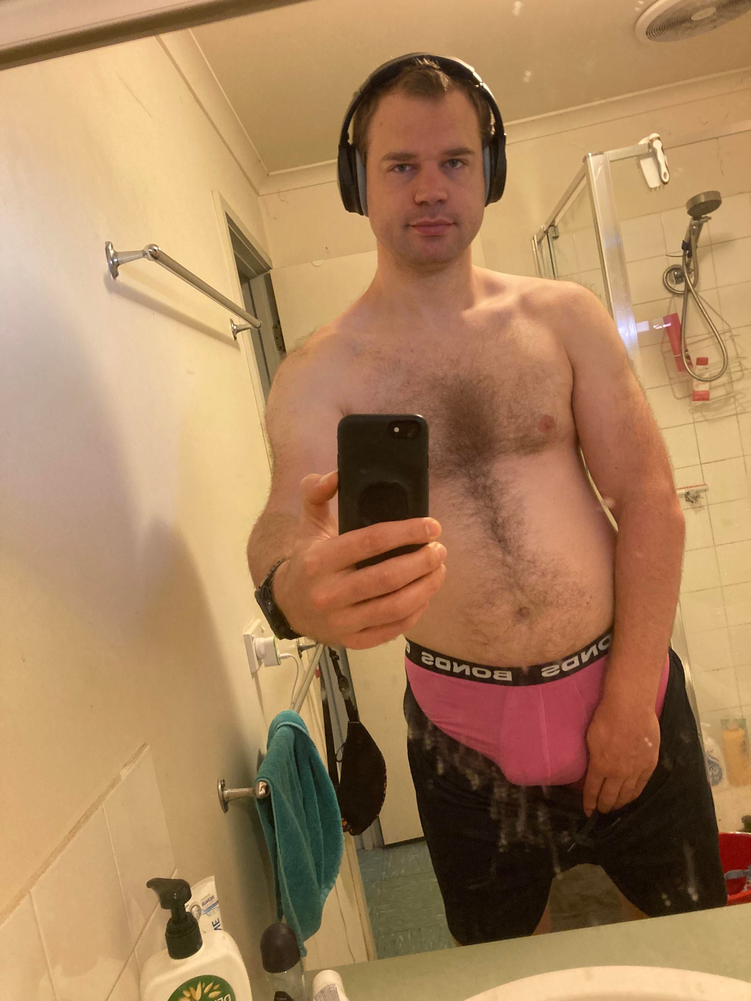 bathroom mirror selfie with naked upper body, suggestive pose, and bulge