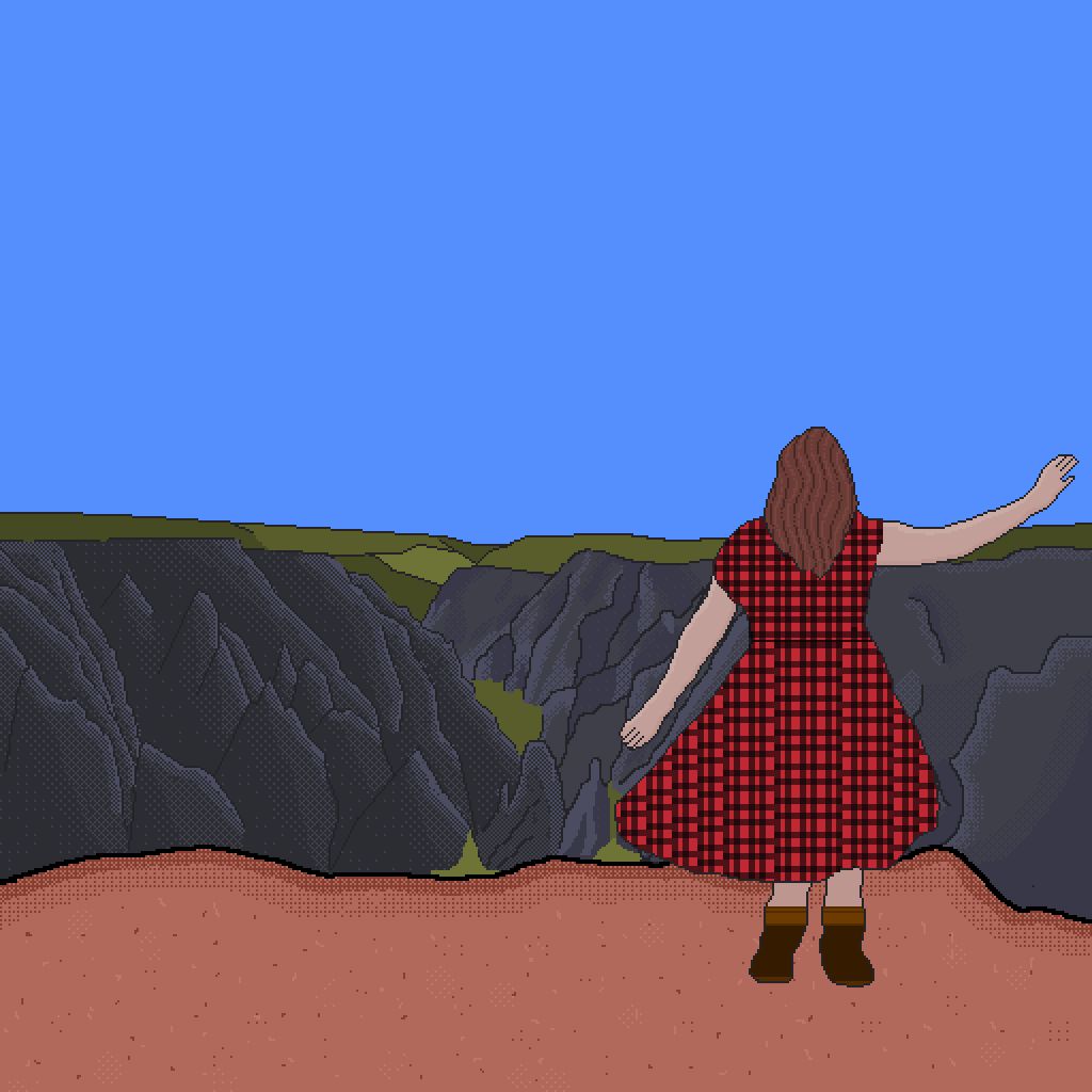Aurora is standing on a cliff looking out over The Black Canyon in Gunnison Colorado. She is wearing a red plaid dress. In front of her the canyon stretches out for as far as you can see into the blue sky. 