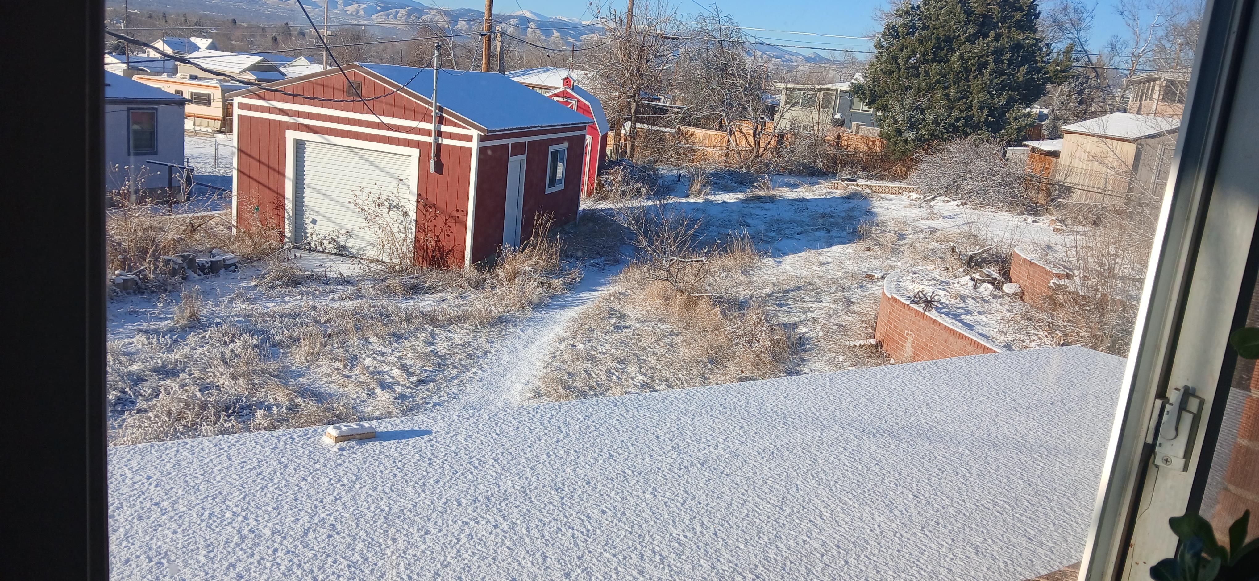 Yard with snow and a workshop 