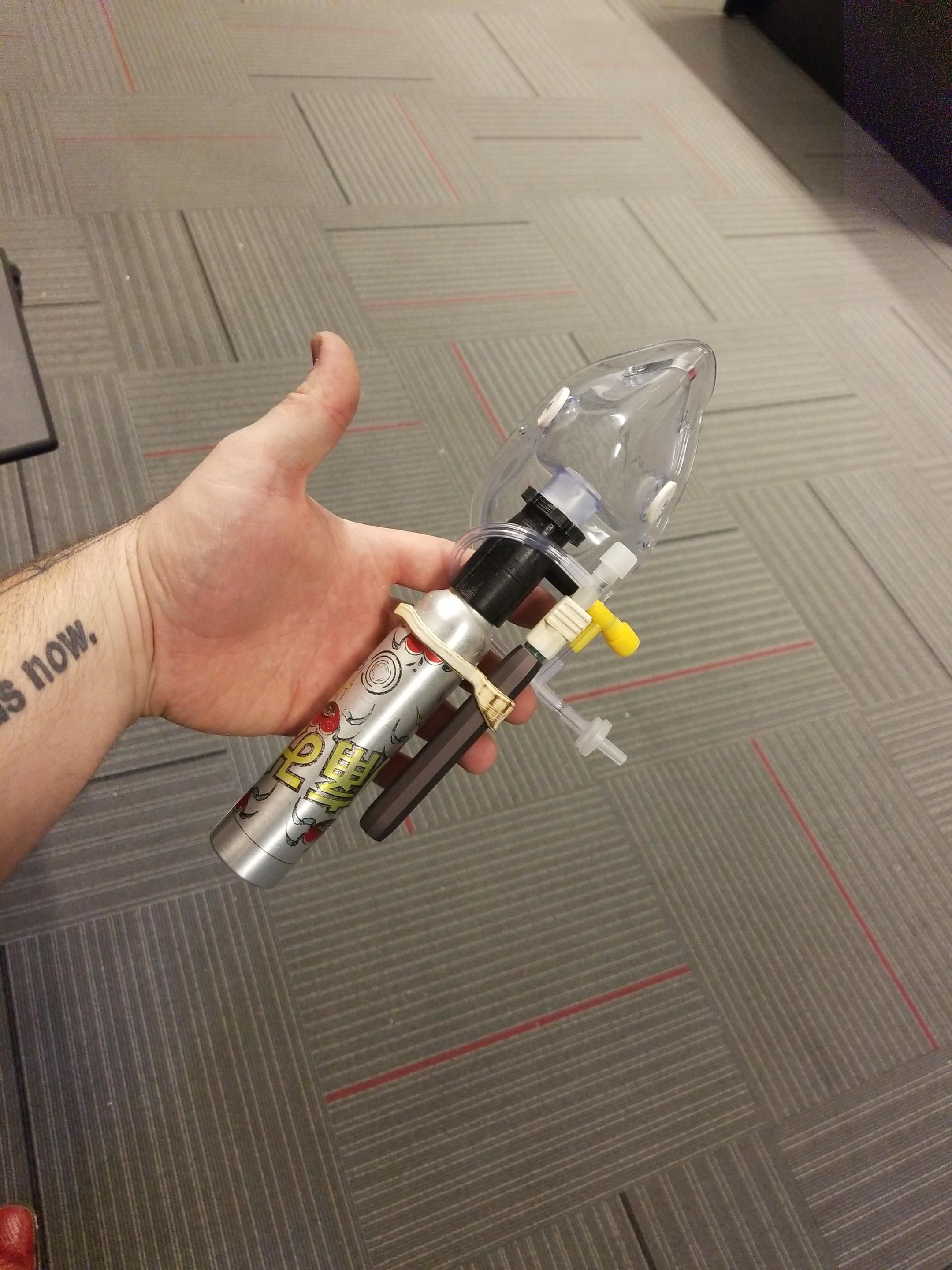 Inhaler device with vinyl tubing, yellowed 3D printed parts, and an oxygen mask.
