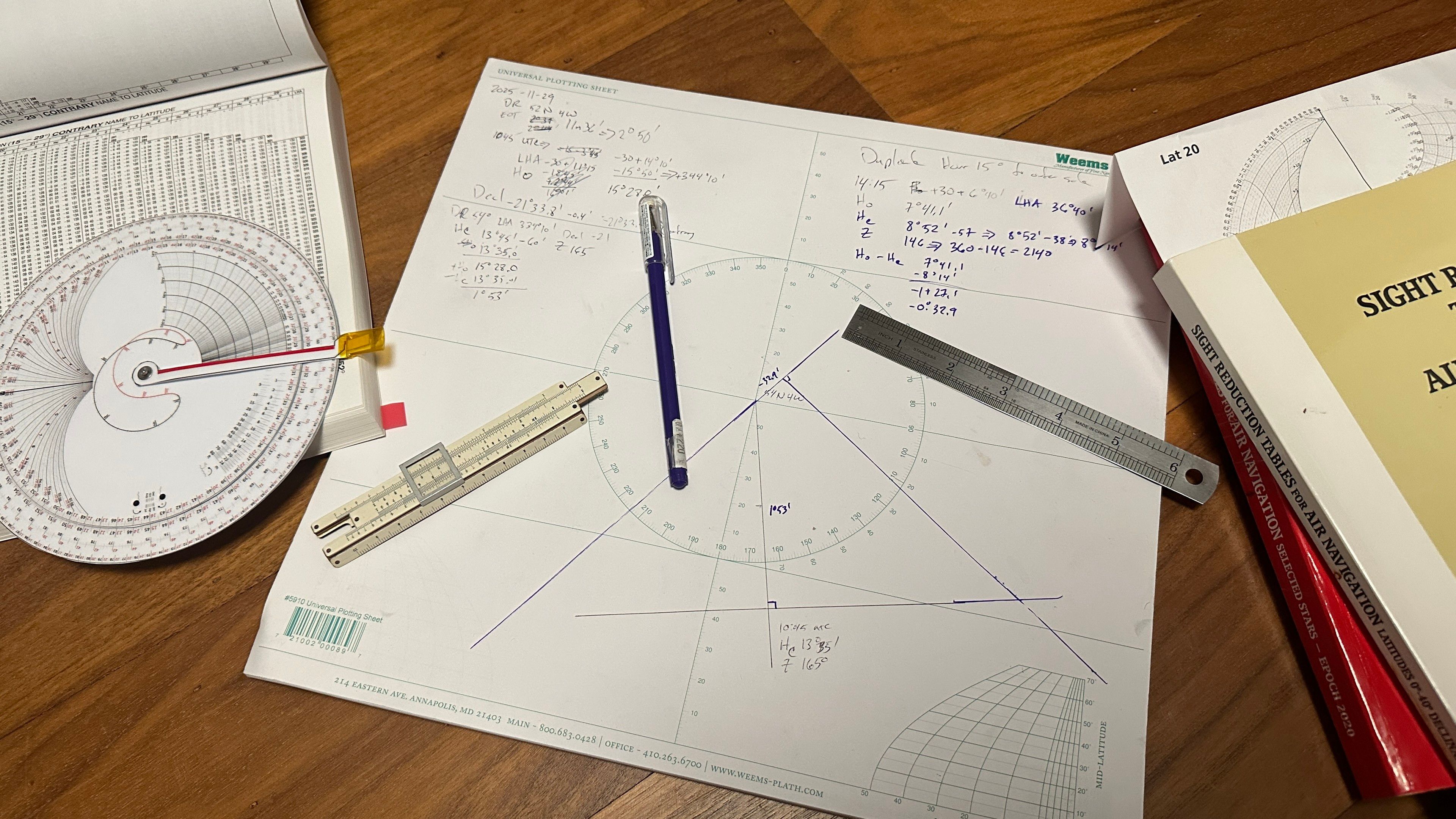 Sight reduction tables, plotting worksheet, normal slide rule and a custom one for degree math. 