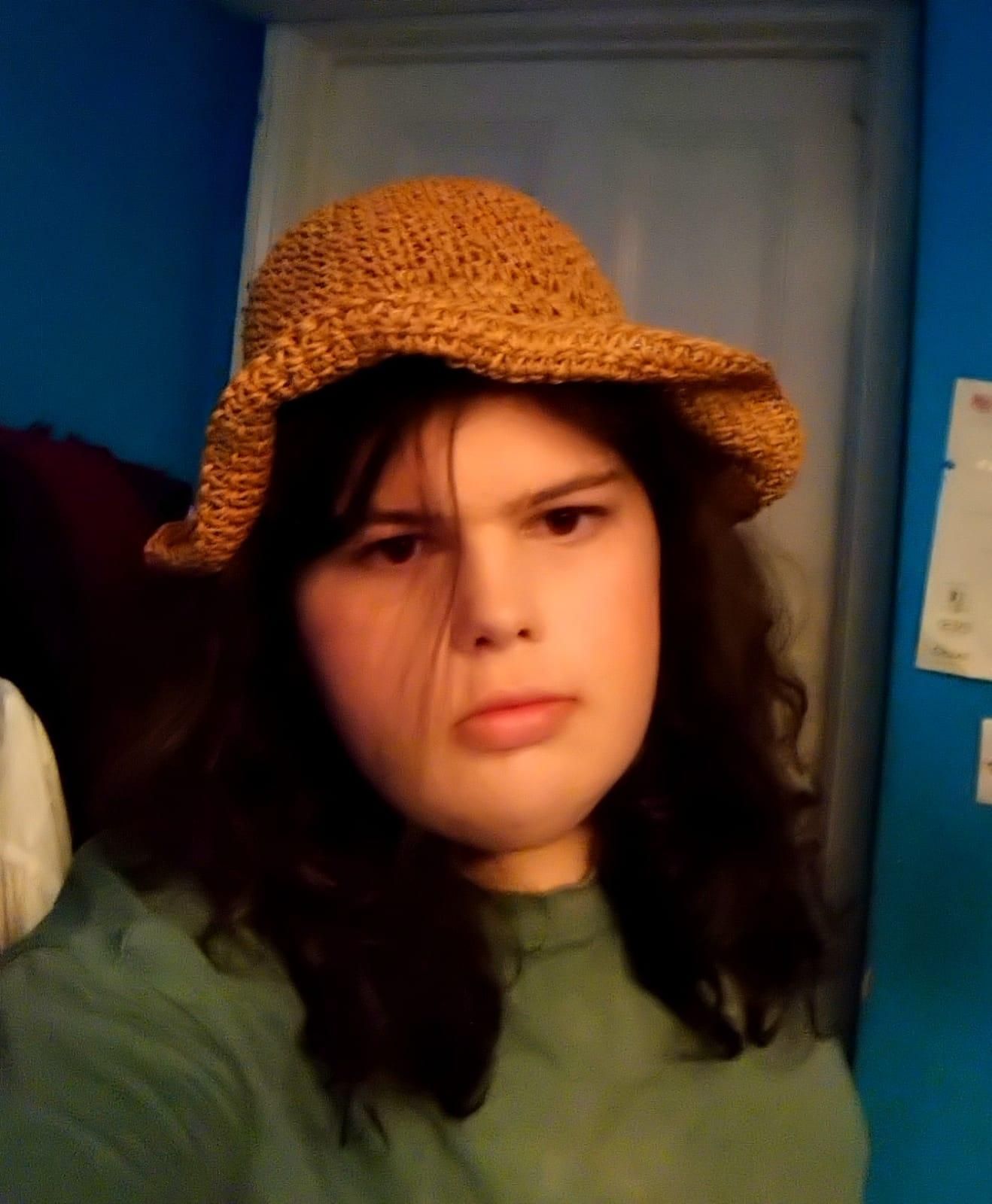 picture of me in a straw hat looking undeniably femme