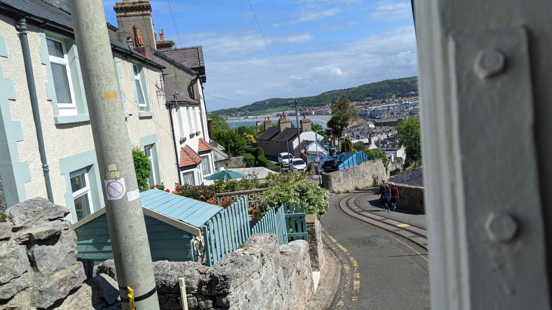 Tramway going steep uphill, view down on the town, sea and beach