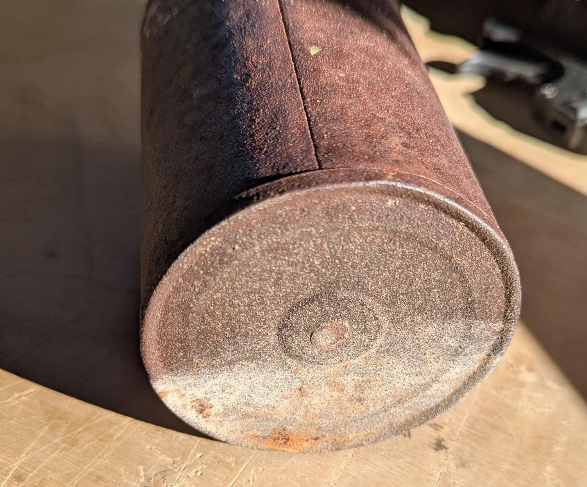 A rusted steel can bottom.