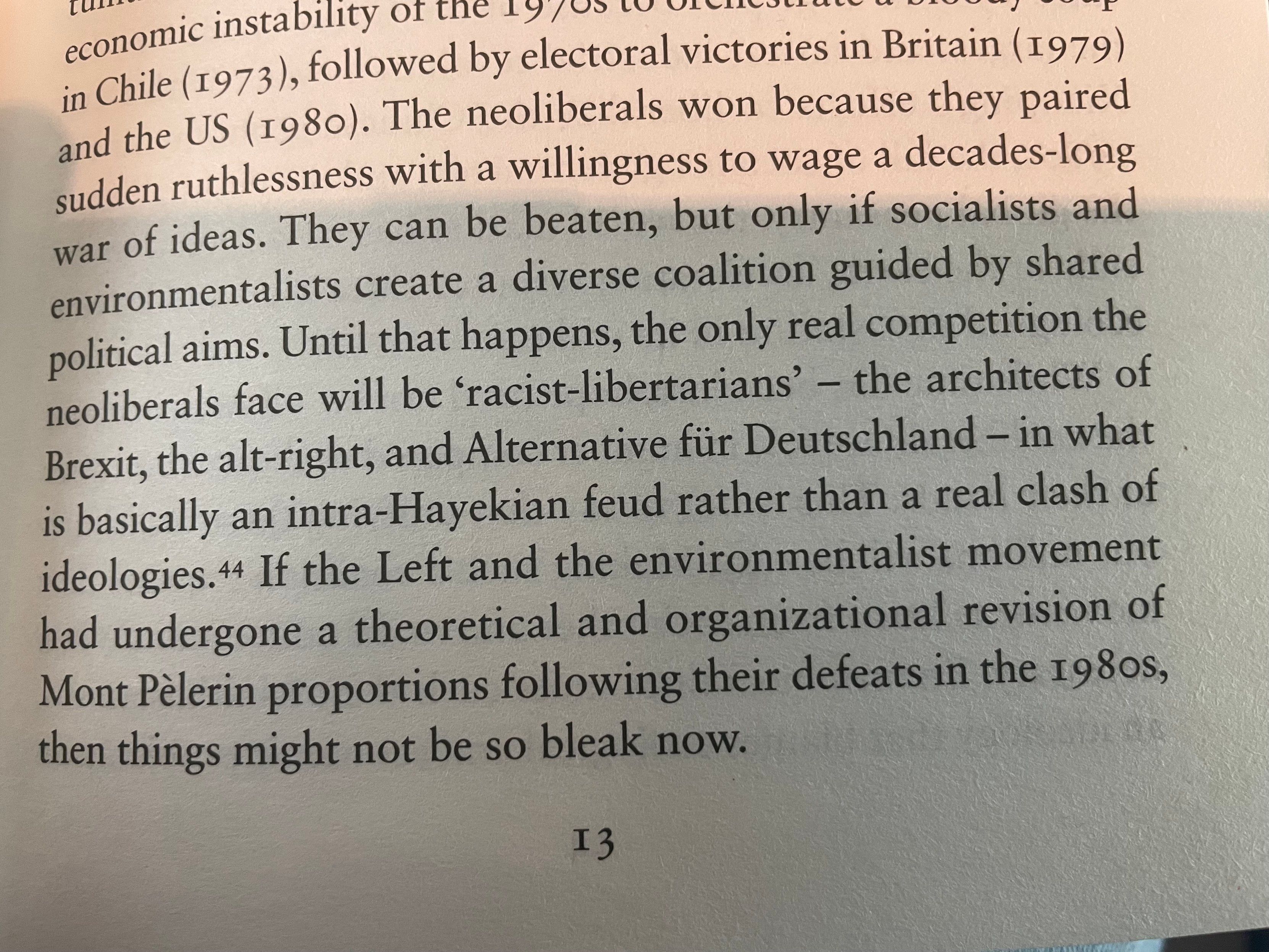 A close-up photo of a printed book page with text regarding political and economic history, mentioning electoral victories in Britain in 1979, the rise of neoliberalism, and the challenges faced by the Left and environmentalist movement.