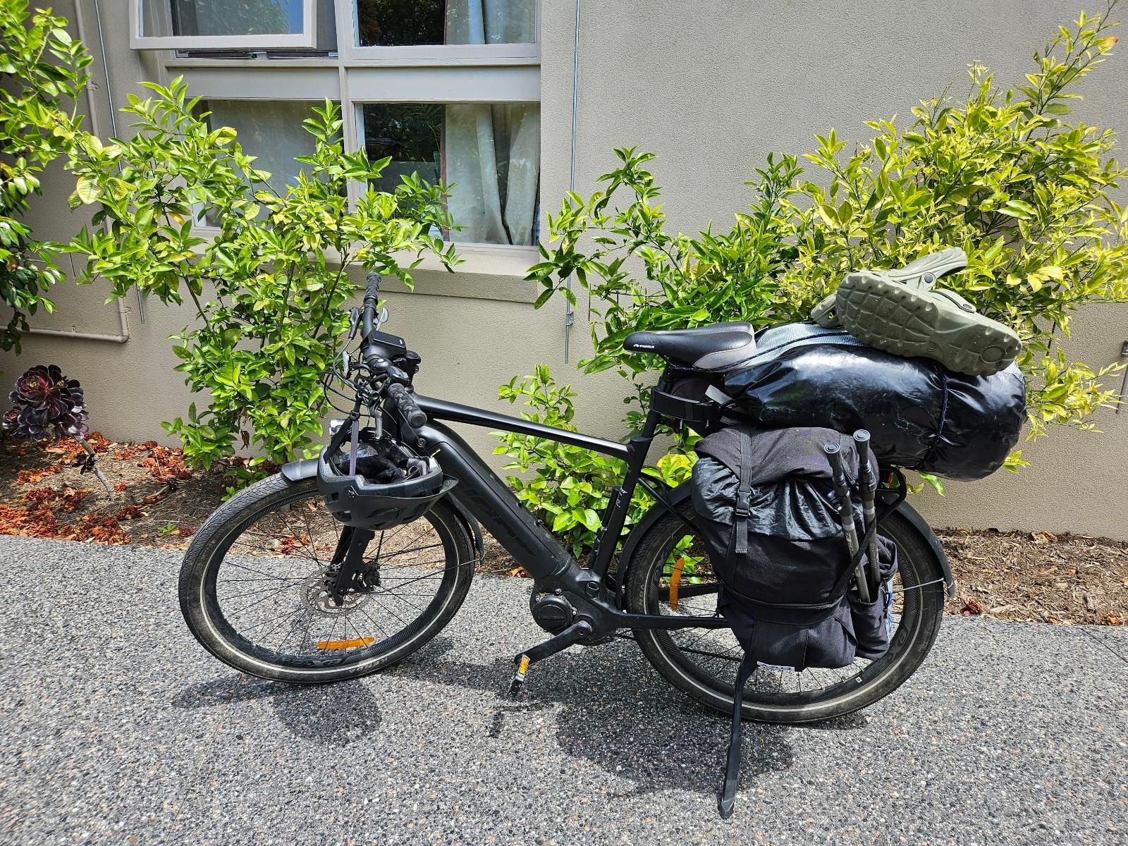 My ebike parked in the driveway, packed to the gills with camping gear, food and clothes.