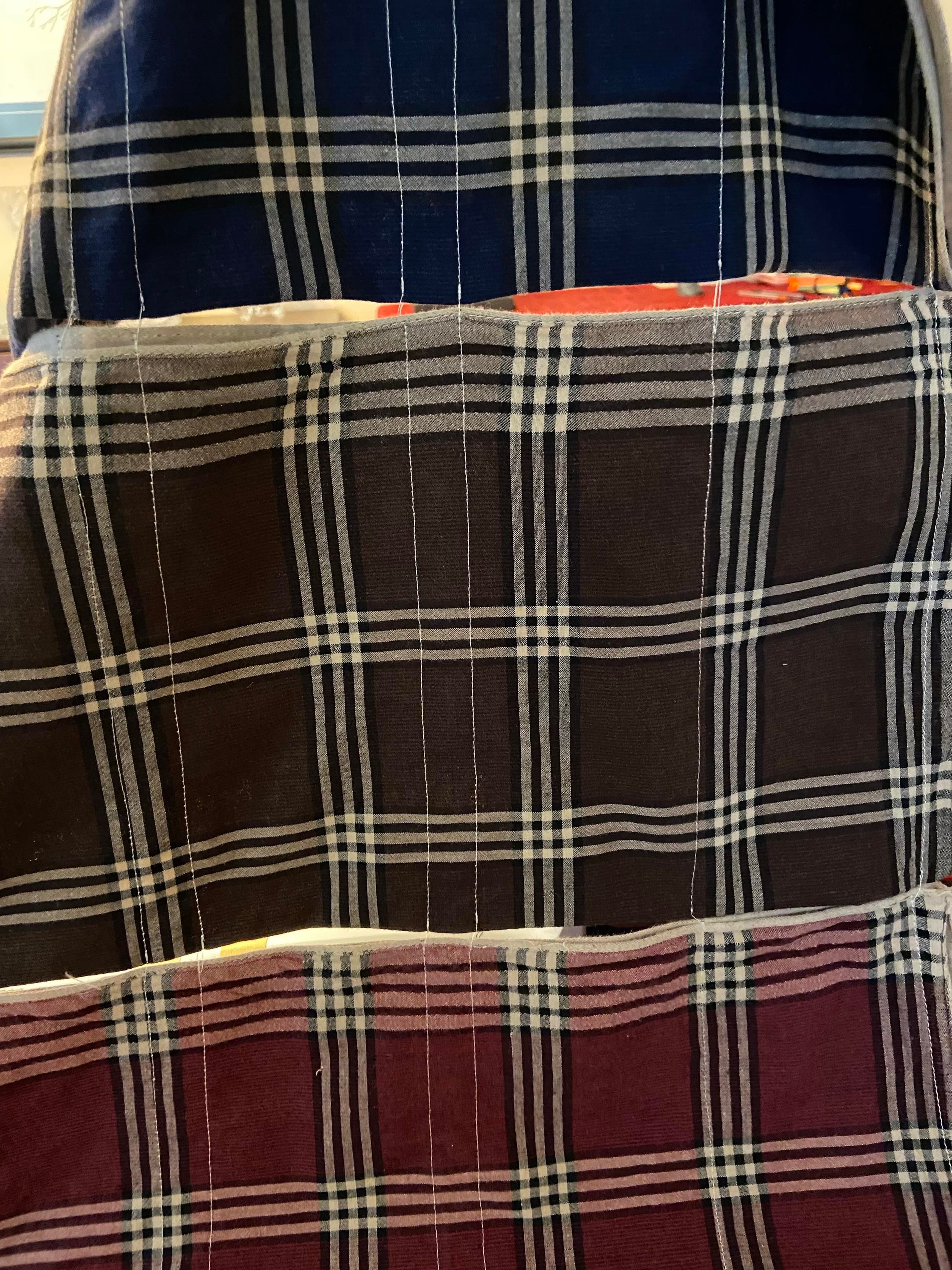 Three folded handkerchiefs that have been chain-stitched