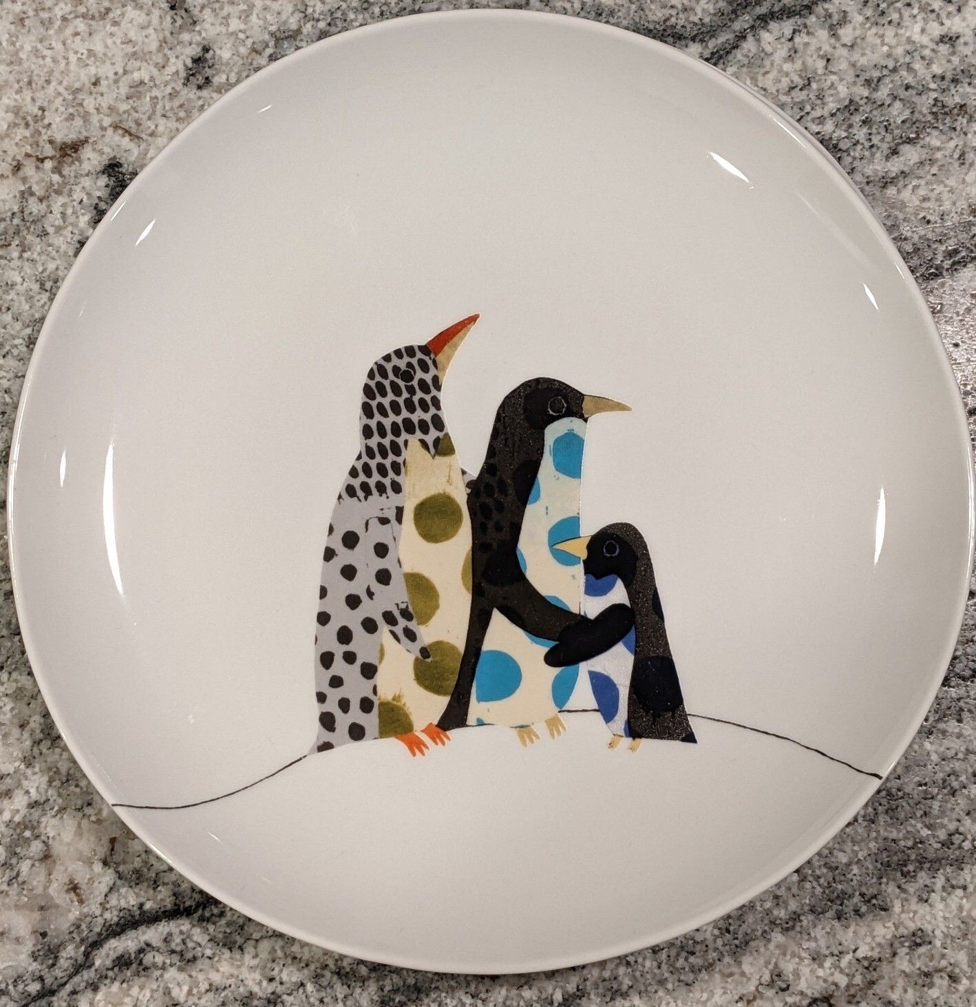 Porcelain plate, picturing polkadot penguins.