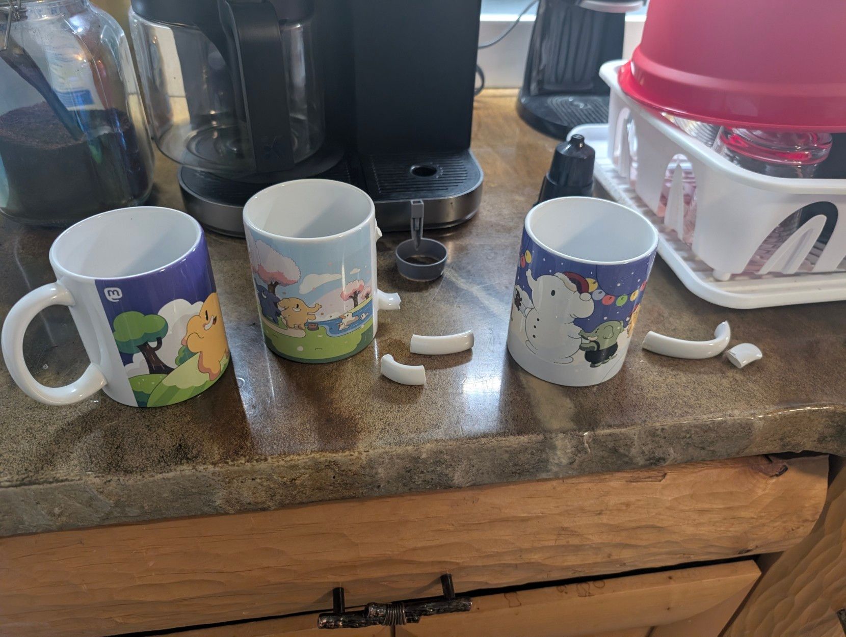 Two mugs with broken handles, one lone survivor