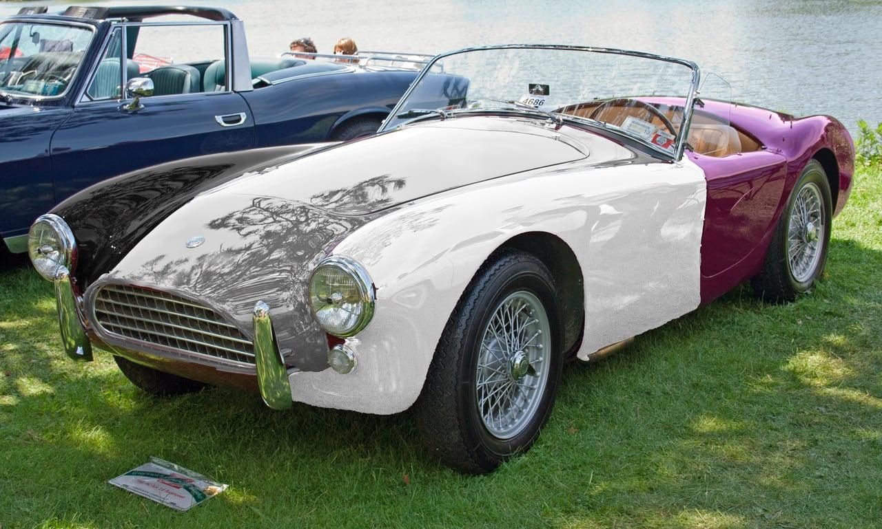 A photo of a classic British roadster AC Ace, crudely edited to be painted in asexual flag colours, VW Harlequin like.

Original image: https://en.wikipedia.org/wiki/AC_Ace#/media/File:1962_AC_Ace_2.6_Ruddspeed_front.jpg