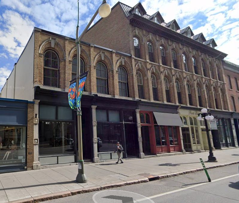A brick street-level late 19th century storefront with lots of character. It's two stories, with a 3 storey-dormered section next door. 