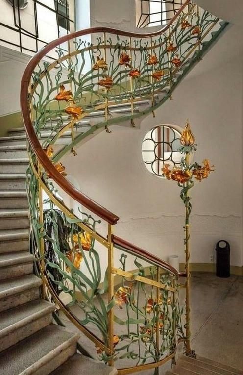 Decorative flowers and stems on balustrade of curving staircase