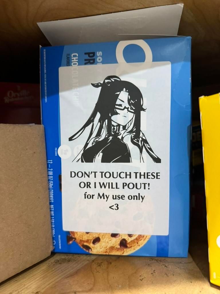 A box of low-carb Quest cookies with a thermal printer sticker on them that has fanart of Xianyun from Genshin Impact pouting and the words:

"DON'T TOUCH THESE
OR I WILL POUT!
for My use only
<3"