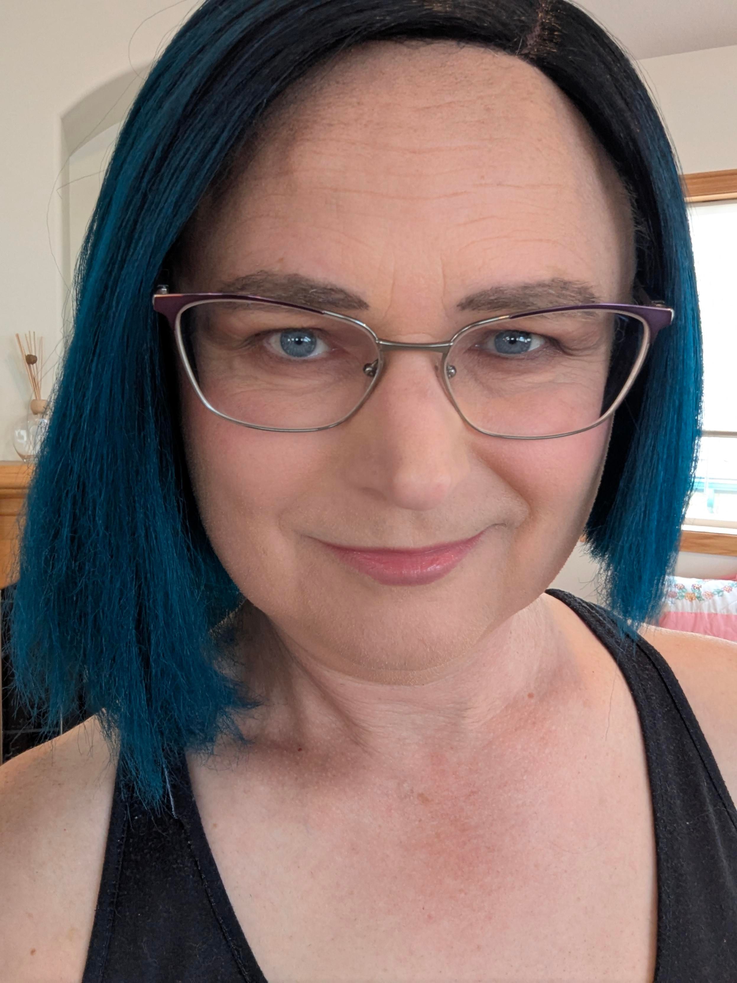 A selfie of me with smoky eyeshadow and my blue wig
