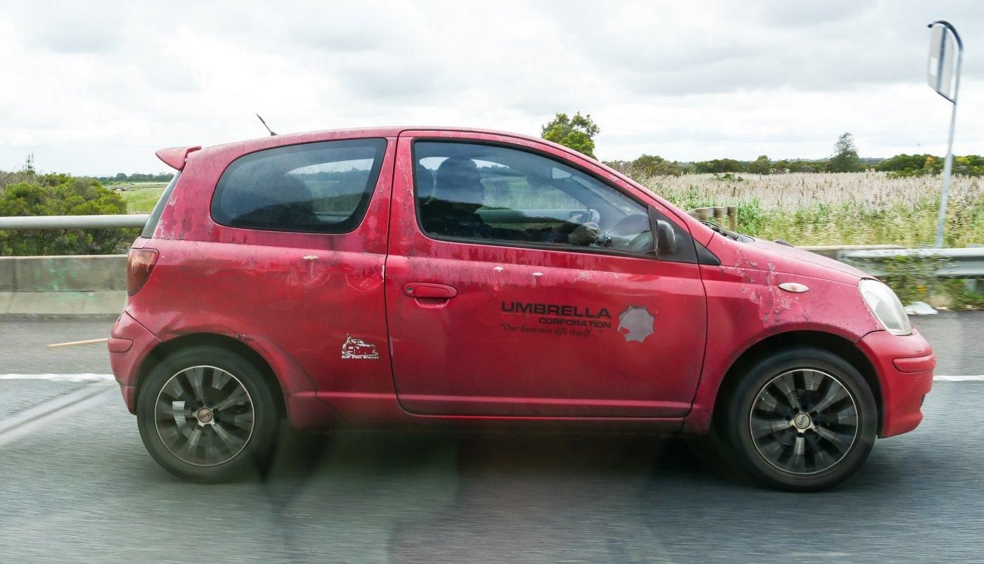 Red Toyota Echo that's seen better days