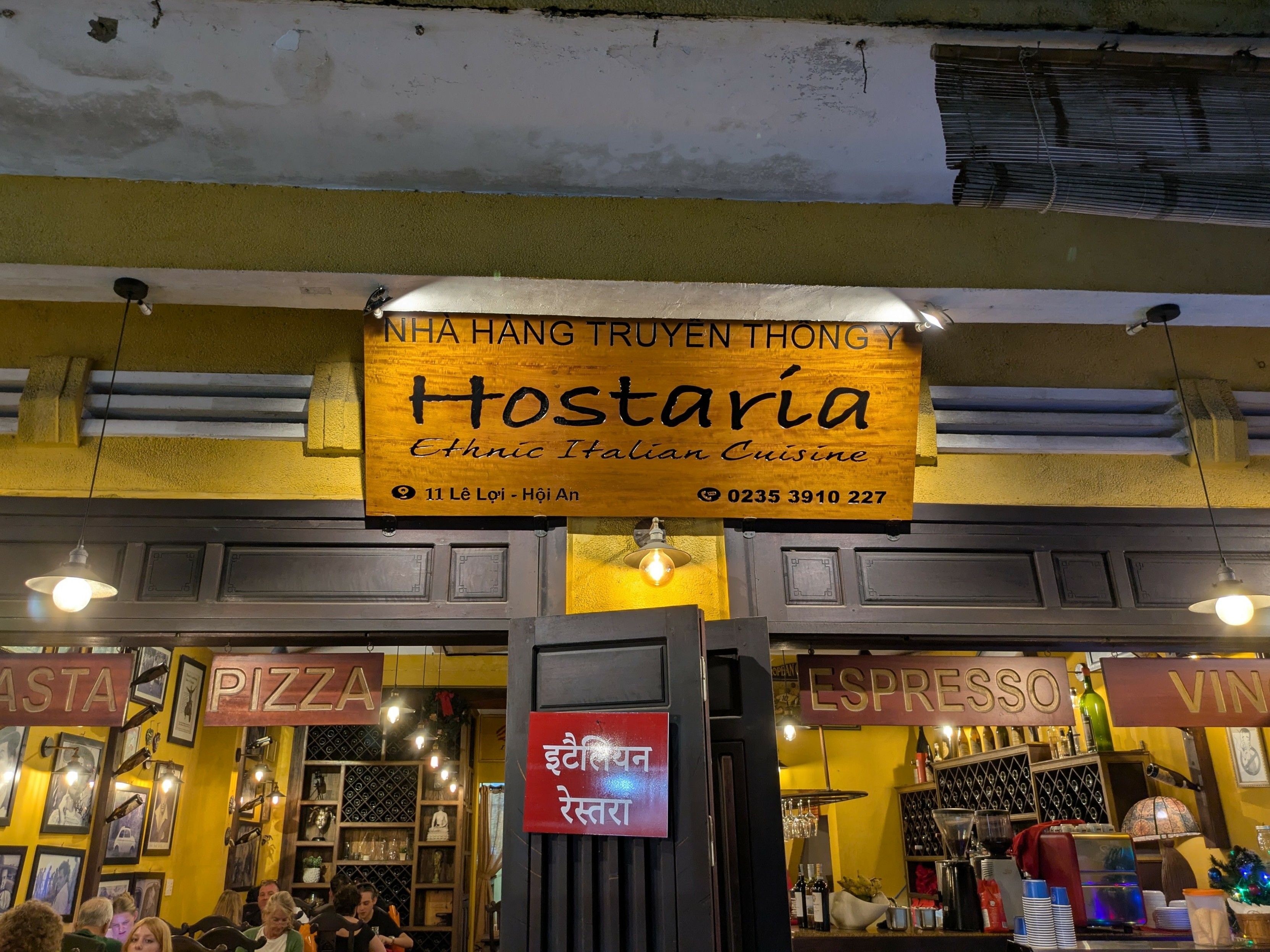 A restaurant front with the sign saying "Ethnic Italian Cuisine" under the name.