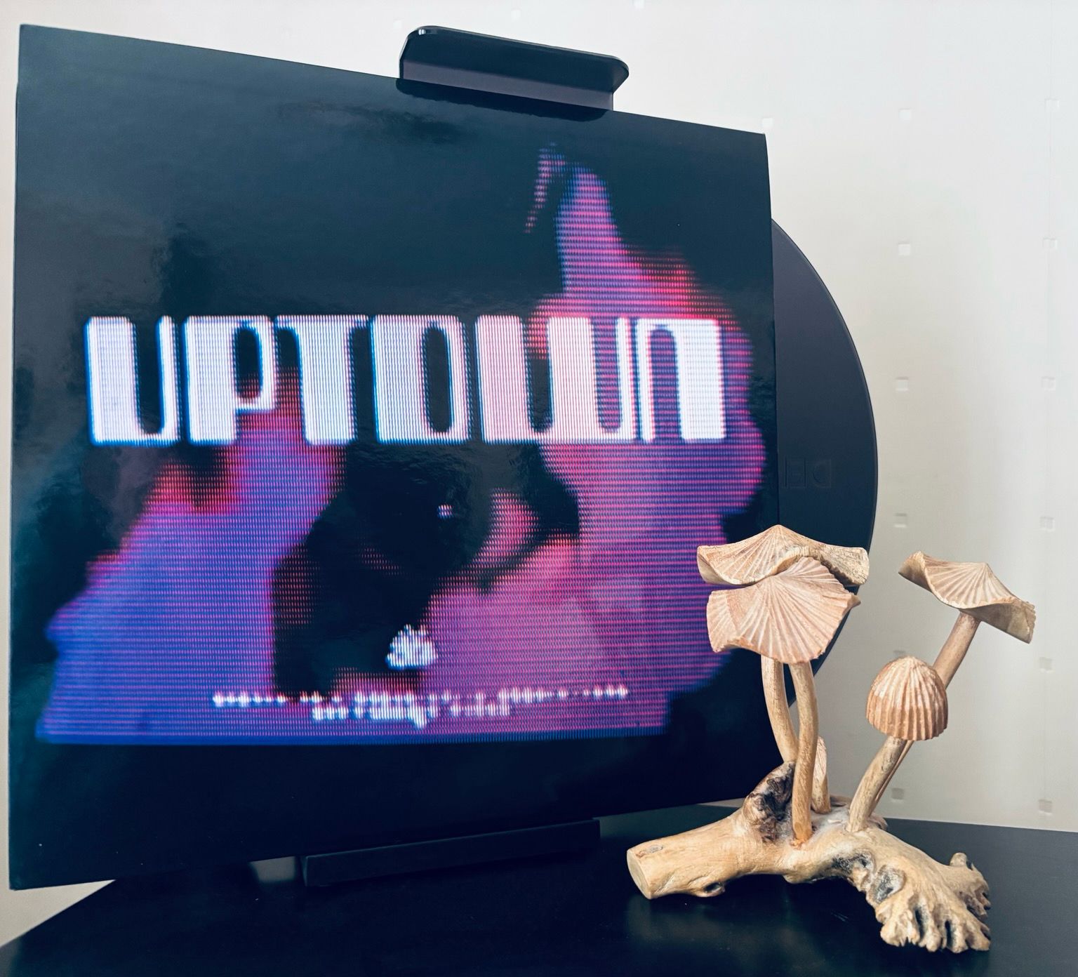 A grainy eye with the text ‘Uptown’ in what looks like the same font used for 54321 chocolate biscuit bars. 