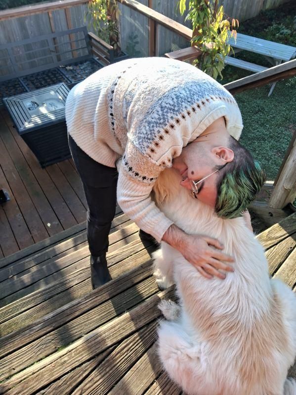 Me hugging the same fluffy doggy, different angle. I am still cozy but also attractive.