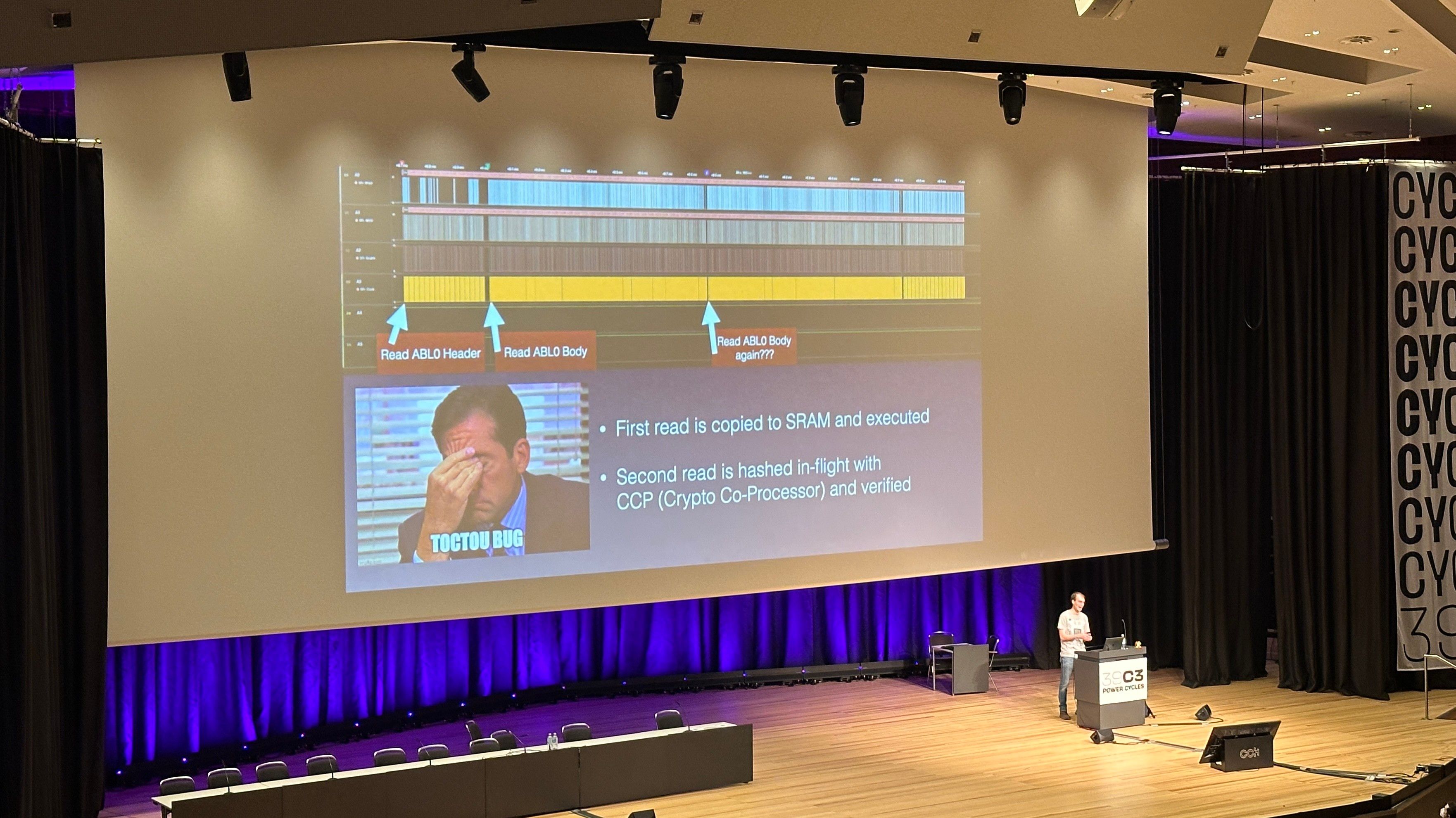 Person on stage showing a slide with face palm mistake in SPI trace of two reads of off chip boot rom. 