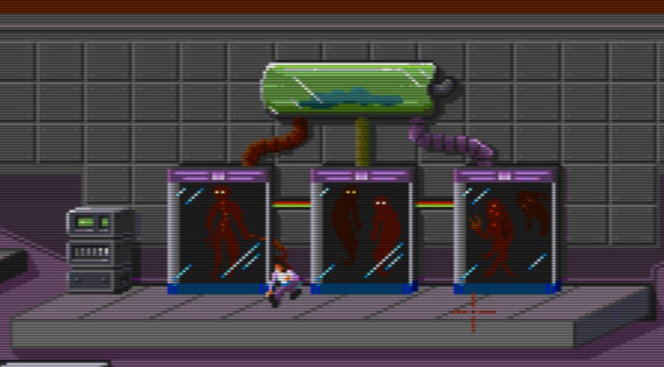 The screenshot shows part of room 23 where, over a platform, there is a fainted man between to glass cages, and a third one on the extreme right, with redish creatures inside.
Above the cages there is another glass container with green fuids inside and a shadow of what it seems to be a human being, lying on the bottom.