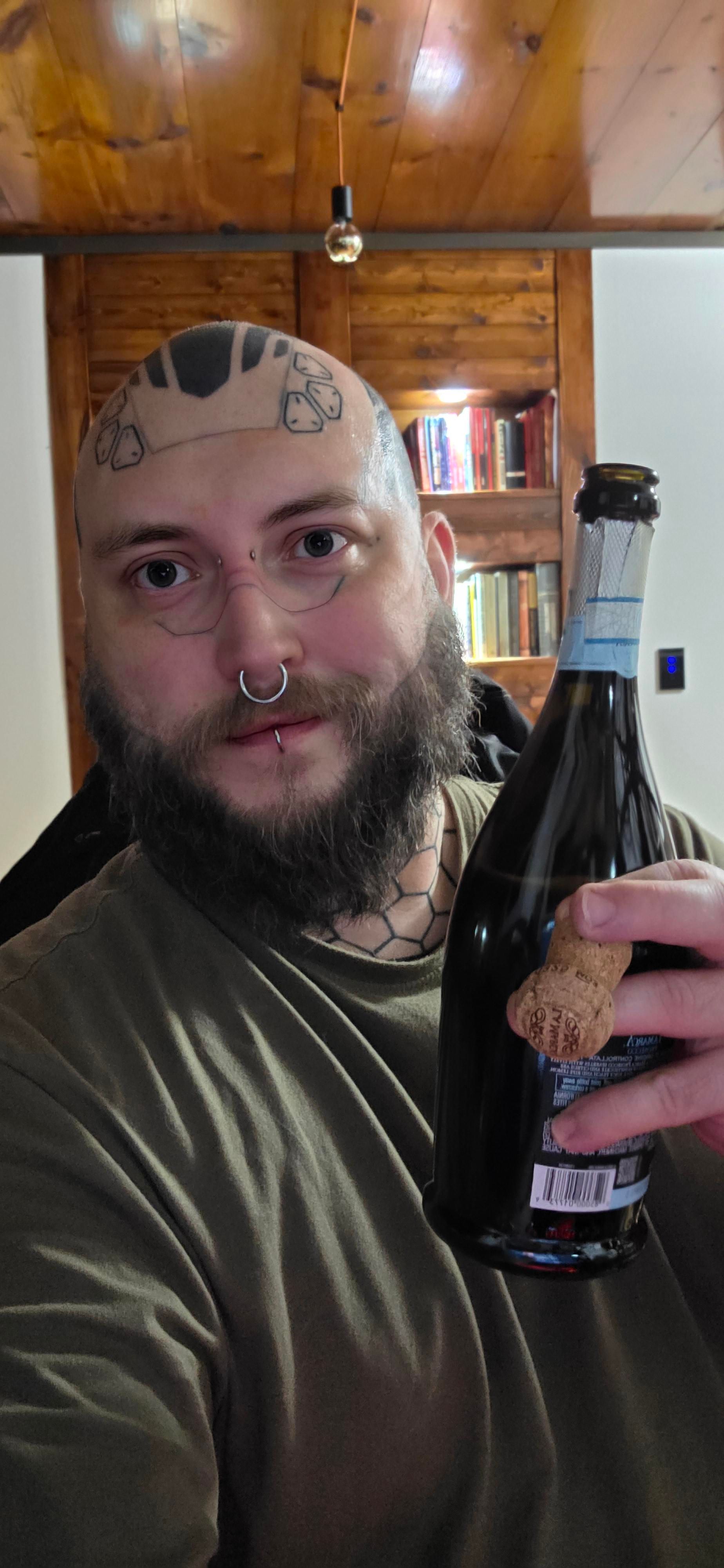 Selfie, holding a bottle of sparkling wine