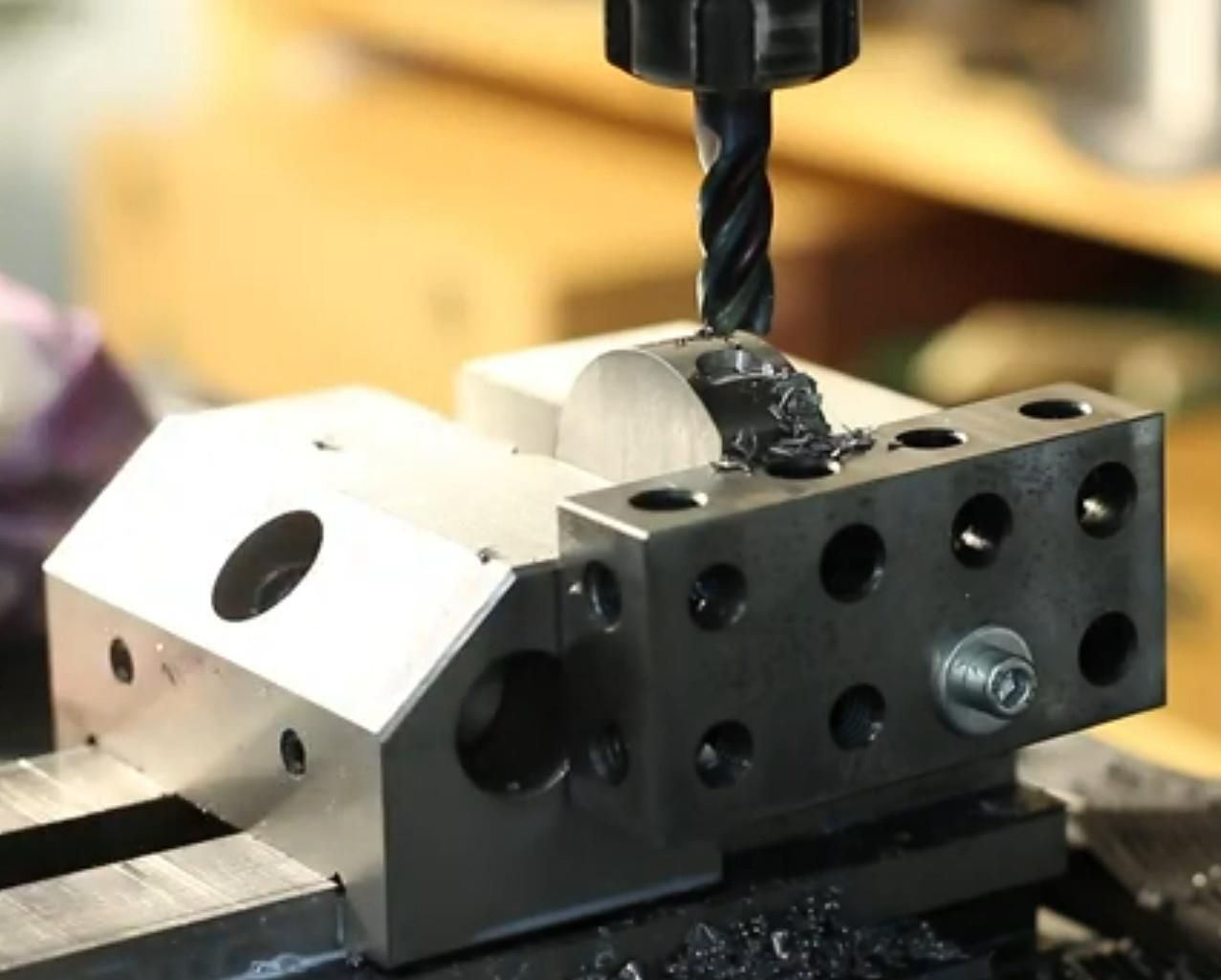 A precision vise with a 1-2-3 block bolted on the side