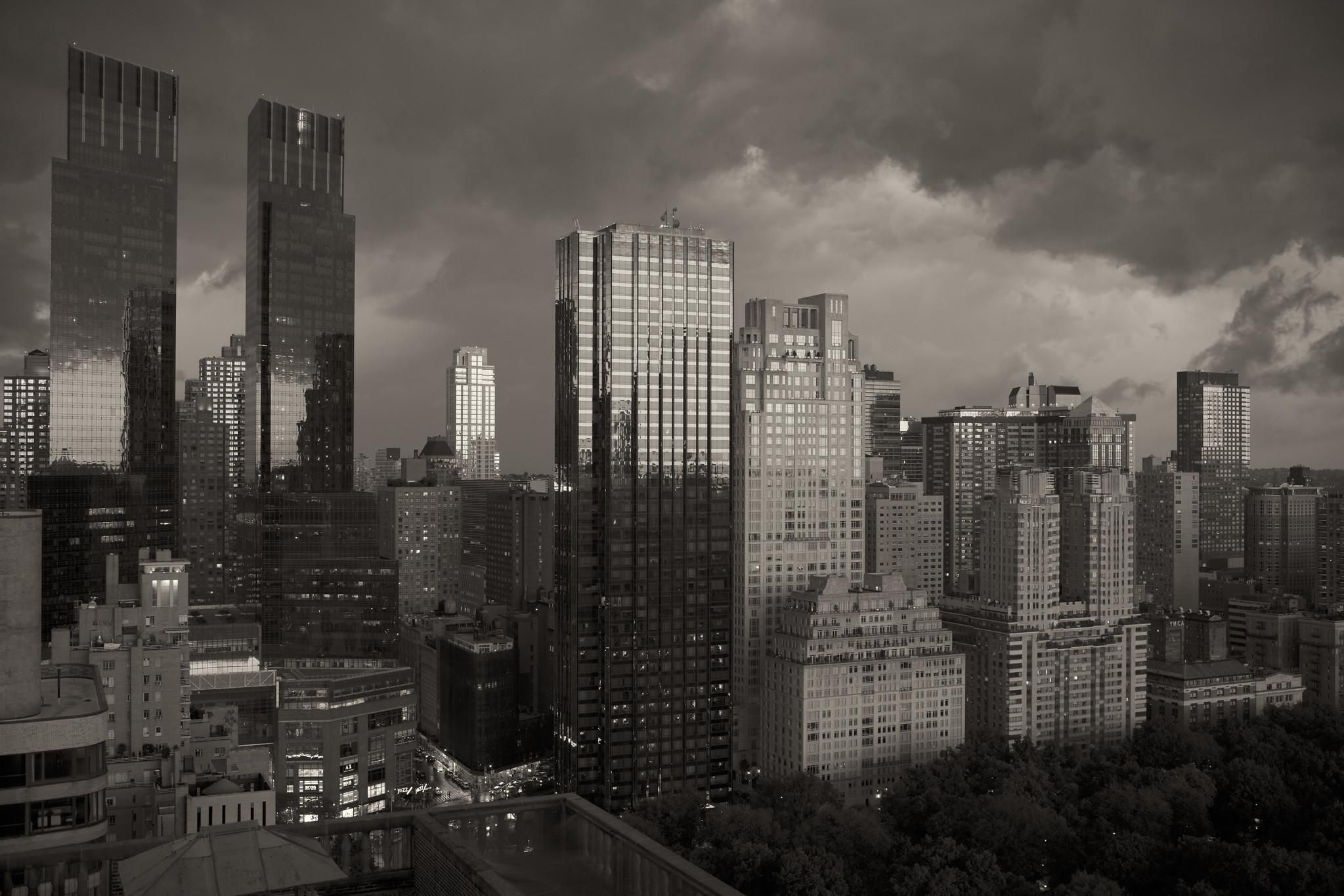 Skyline of the Upper West Side of NYC along lower Central Park West, captured from a high vantage point. A storm is brewing.