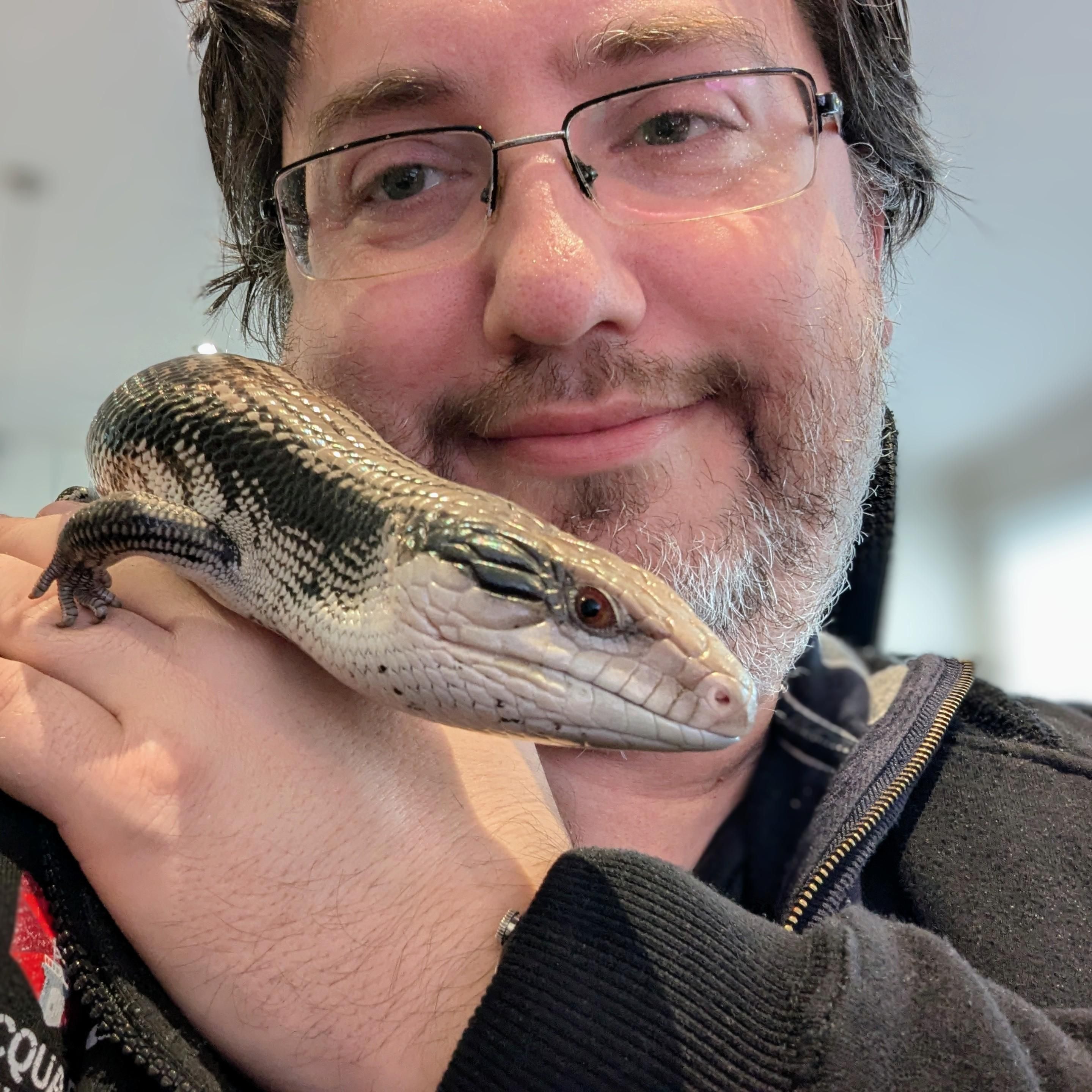 Photo of a man holding an Eastern Blue Tongue Skink.