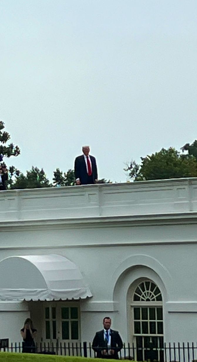 Trump standing on the roof of the White House