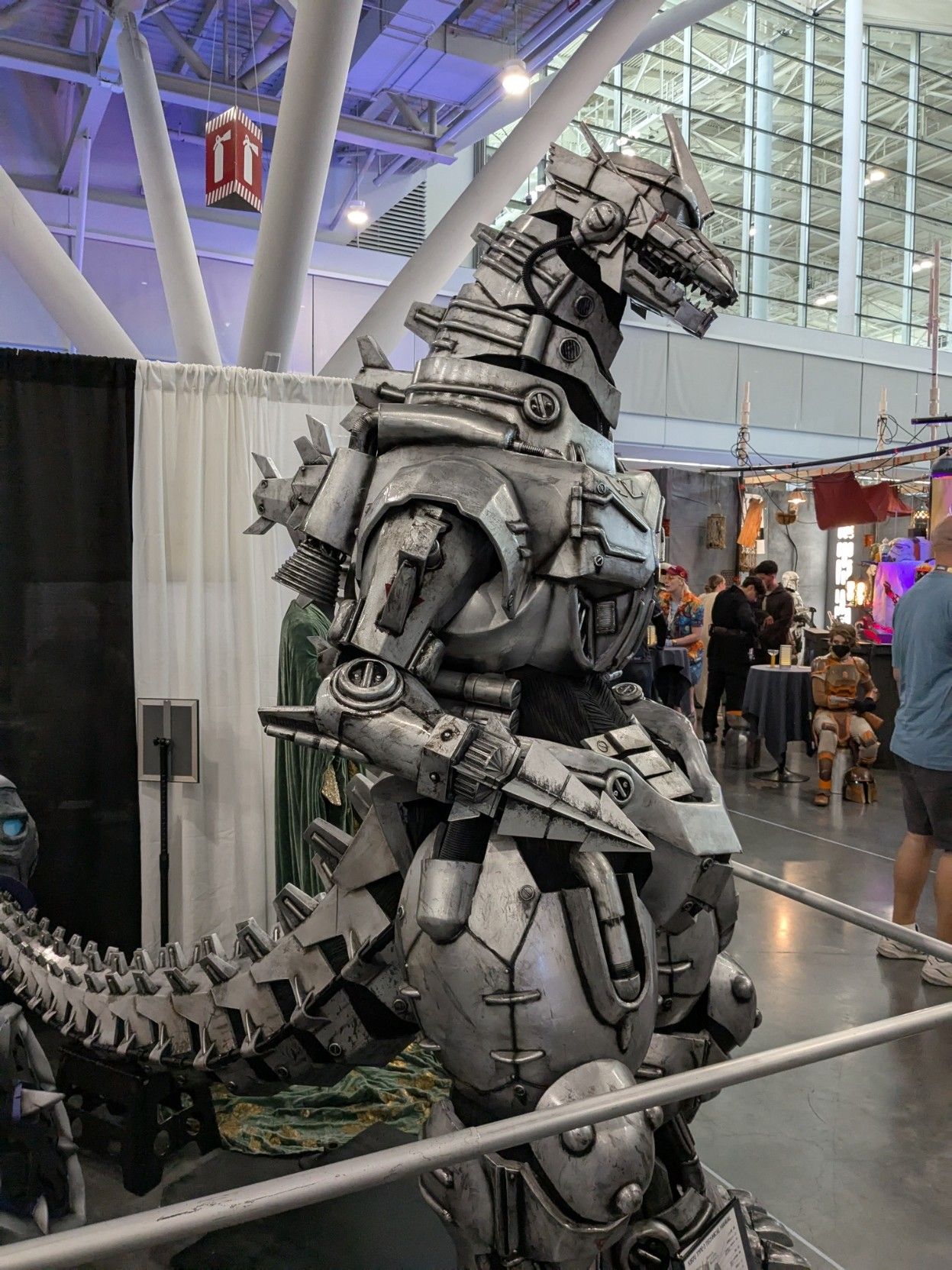 A giant mecha Godzilla costume in an expo hall