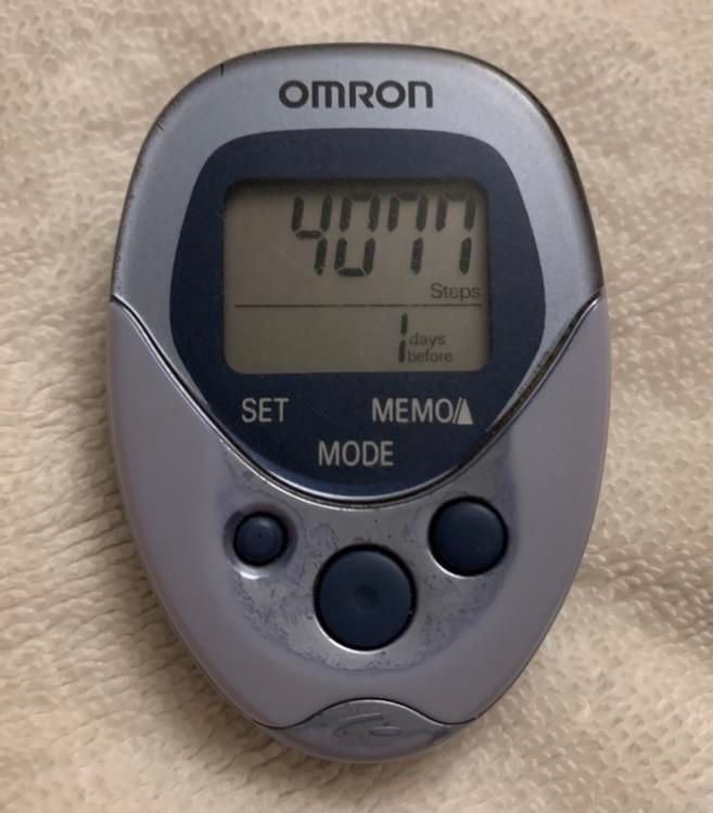 A small gunmetal blue Omron step counter digital display shows "4077" as the total stepcount one day prior. The long-running American TV situation-dramedy M*A*S*H, set during the Korean War, follwed the antics and exploits of members of the M*A*S*H 4077 mobile surgical hospital.
