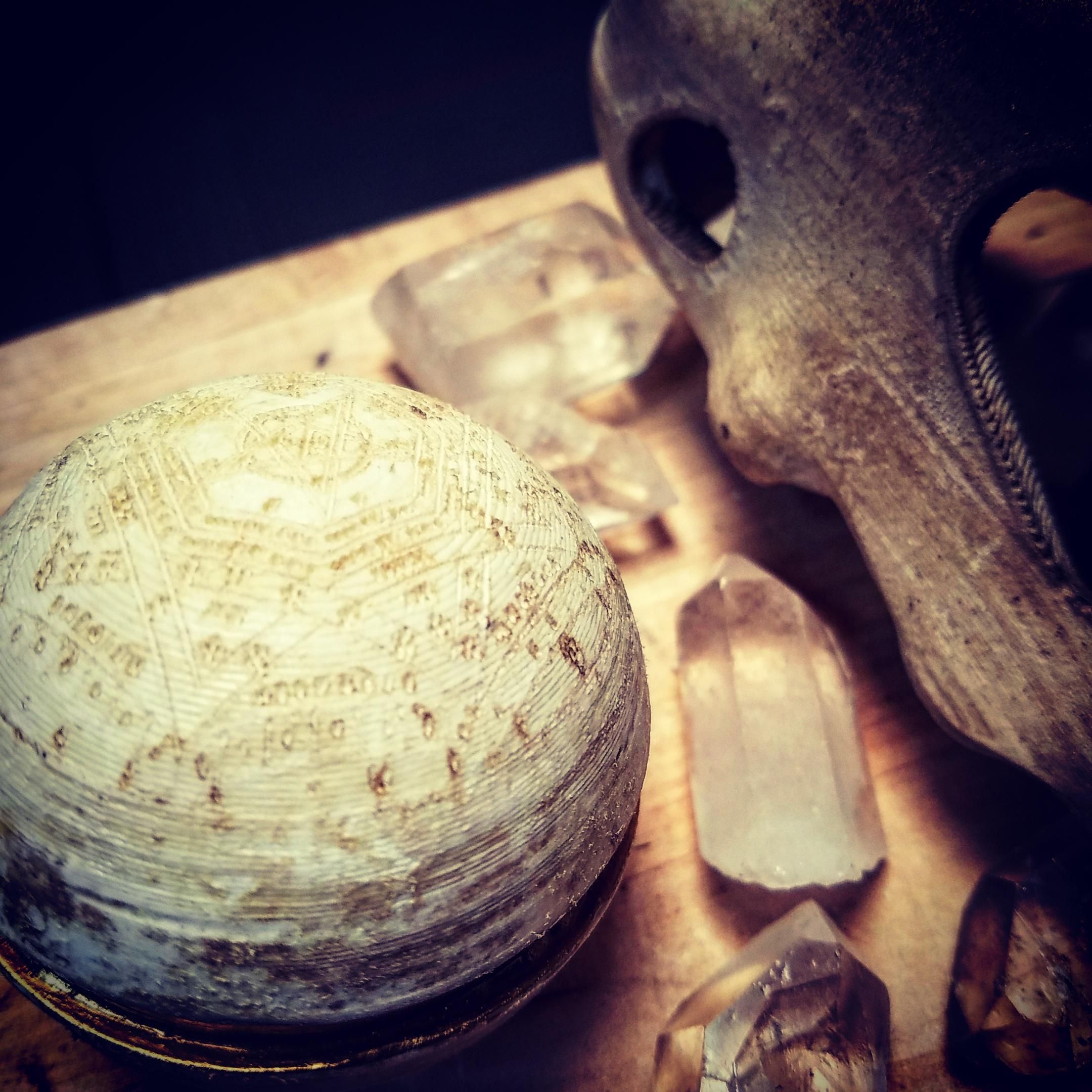 The occult pokeball arranged on a table with crystals and a Cubone skull